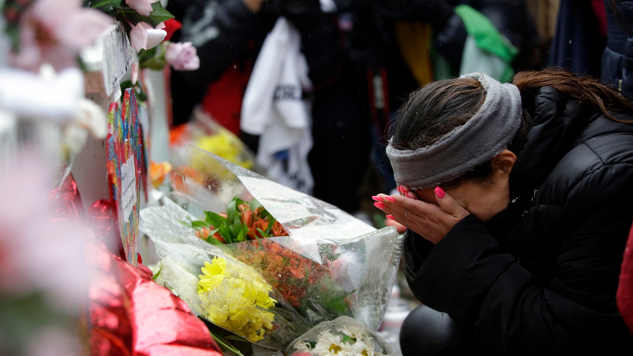 Diana Juarez wipes away tears as she mourns the lost of her father Vicente Juarez during a prayer vigil outside Henry Pratt Company on Feb. 17, 2019, in Aurora, Illinois. (Credit: Joshua Lott/Getty Images)