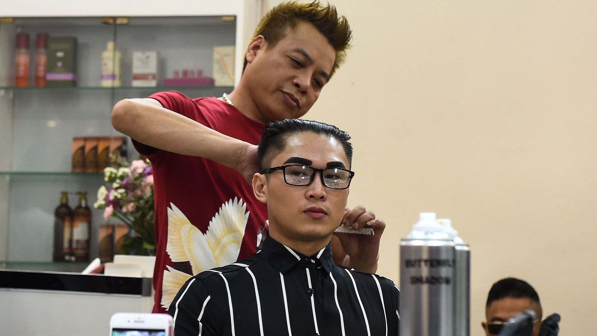 Vietnamese man, Nguyen Huu Thien gets a North Korean leader Kim Jong Un style haircut at a saloon in Hanoi on Feb. 20, 2019. (Credit: Nhac Nguyen/AFP/Getty Images)