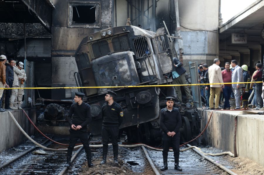 Members of the security forces and onlookers gather at the scene of a fiery train crash at the Egyptian capital Cairo's main railway station on Feb. 27, 2019. (Credit: MOHAMED EL-SHAHED/AFP/Getty Images)