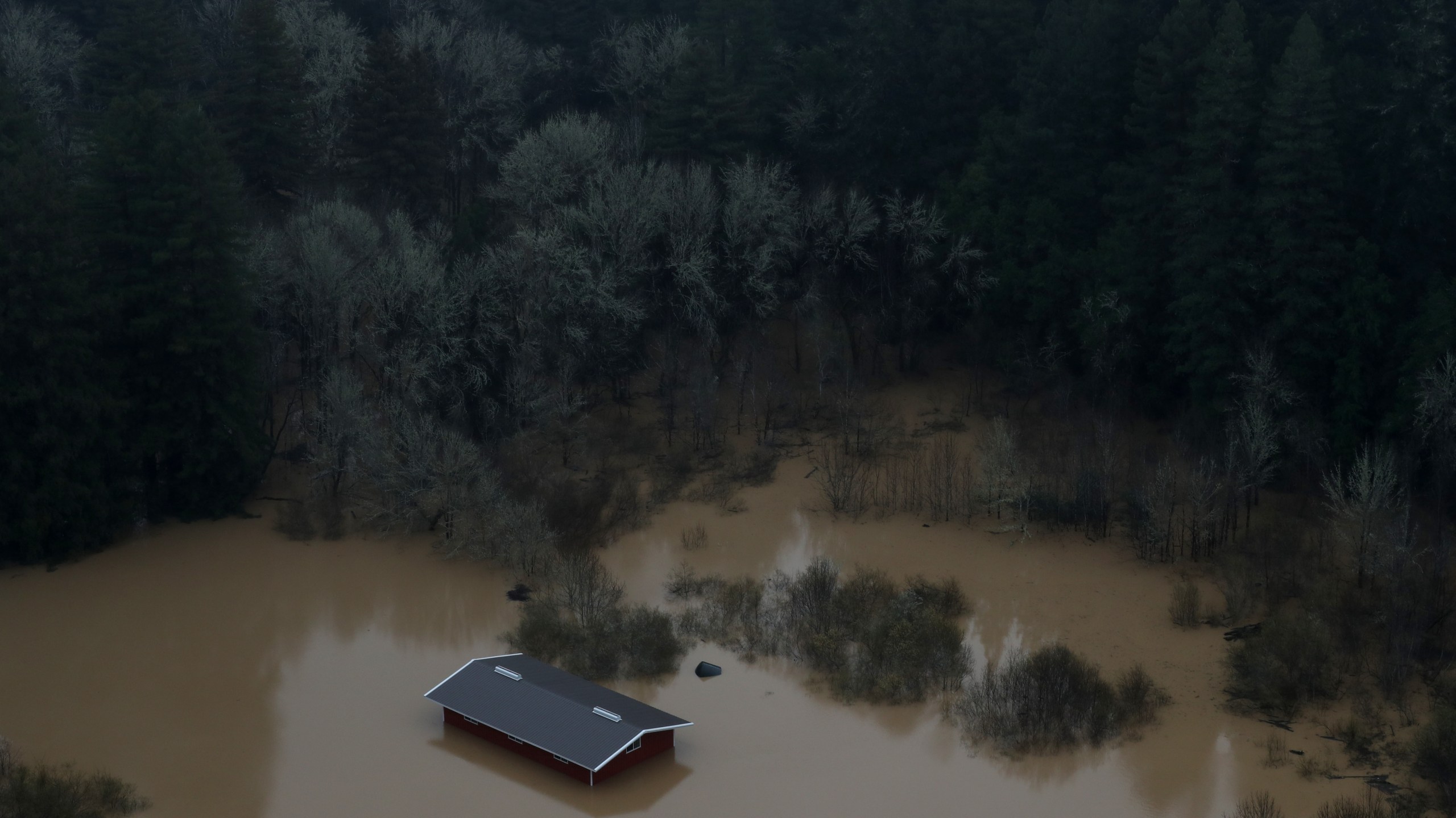 A home sits submerged in floodwaters from the Russian River on Feb. 27, 2019, in Guerneville, Calif. (Credit: Justin Sullivan/Getty Images)