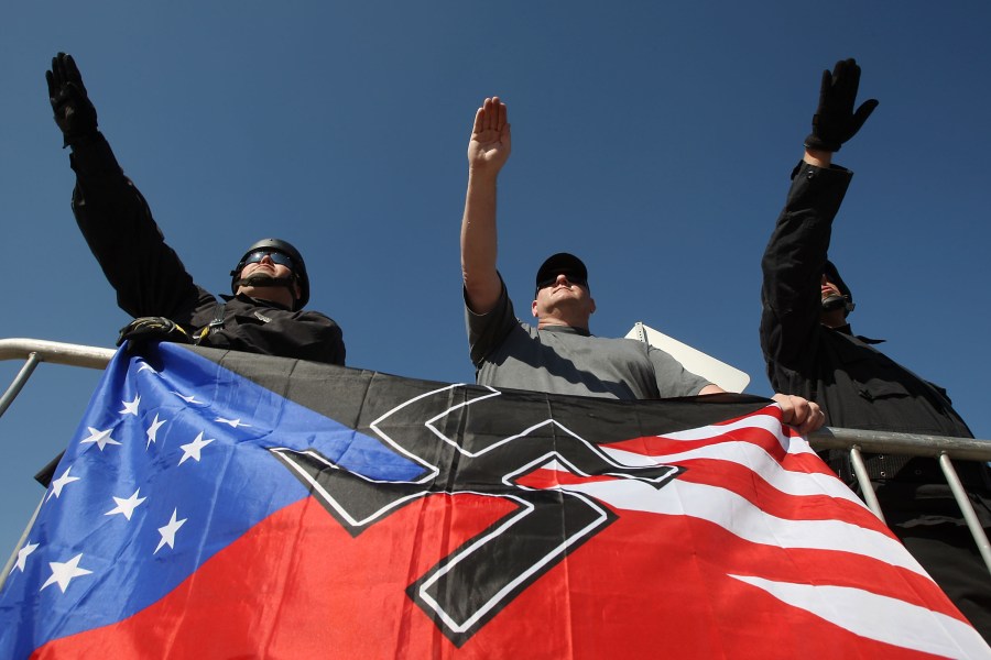 Members of the National Socialist Movement, salute during a rally on Oct. 24, 2009, in Riverside. (Credit: David McNew/Getty Images)