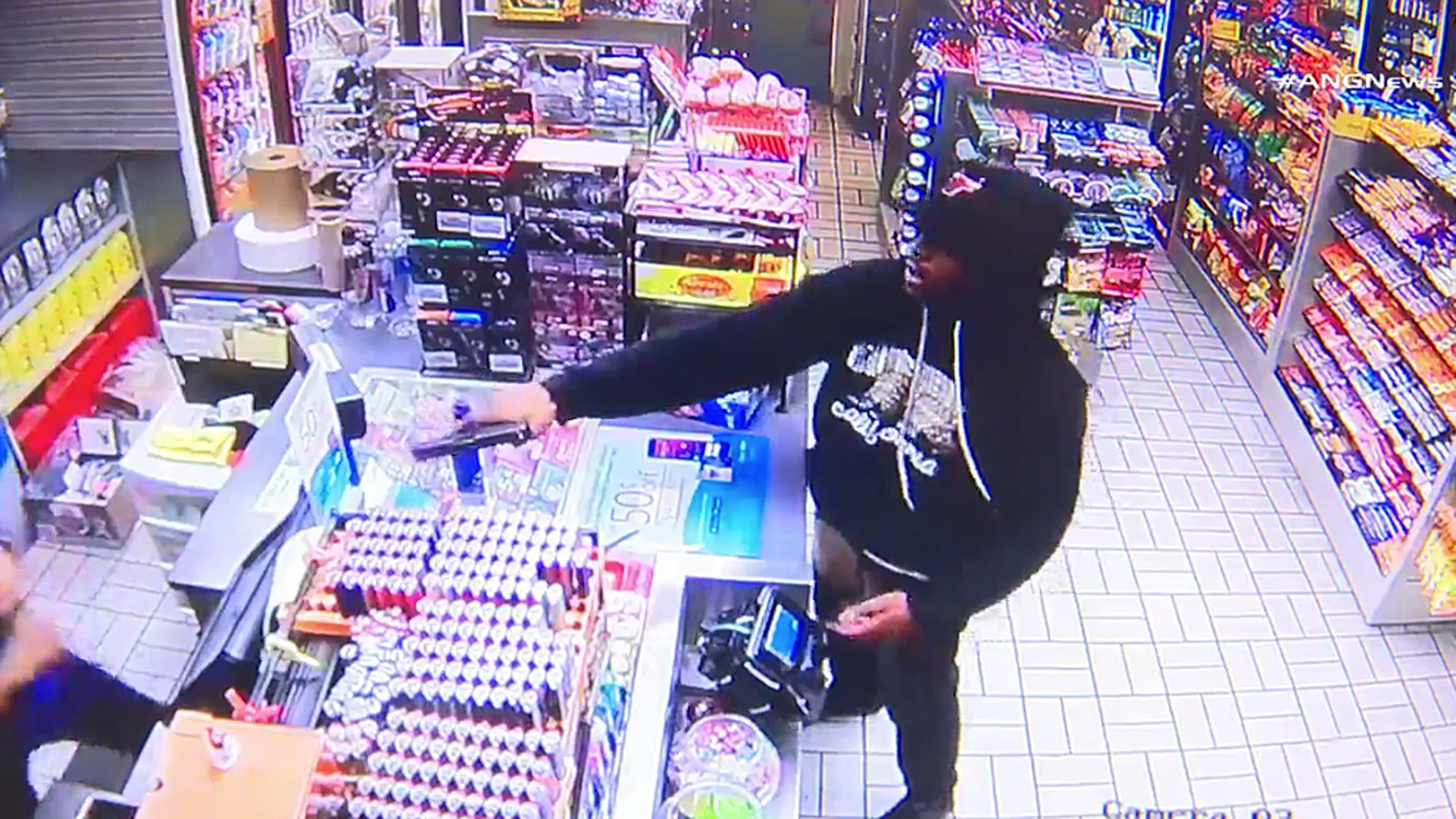 An armed robber holds up a Mobil convenience store in Canoga Park on Feb. 15, 2019. (Credit: ANG News)