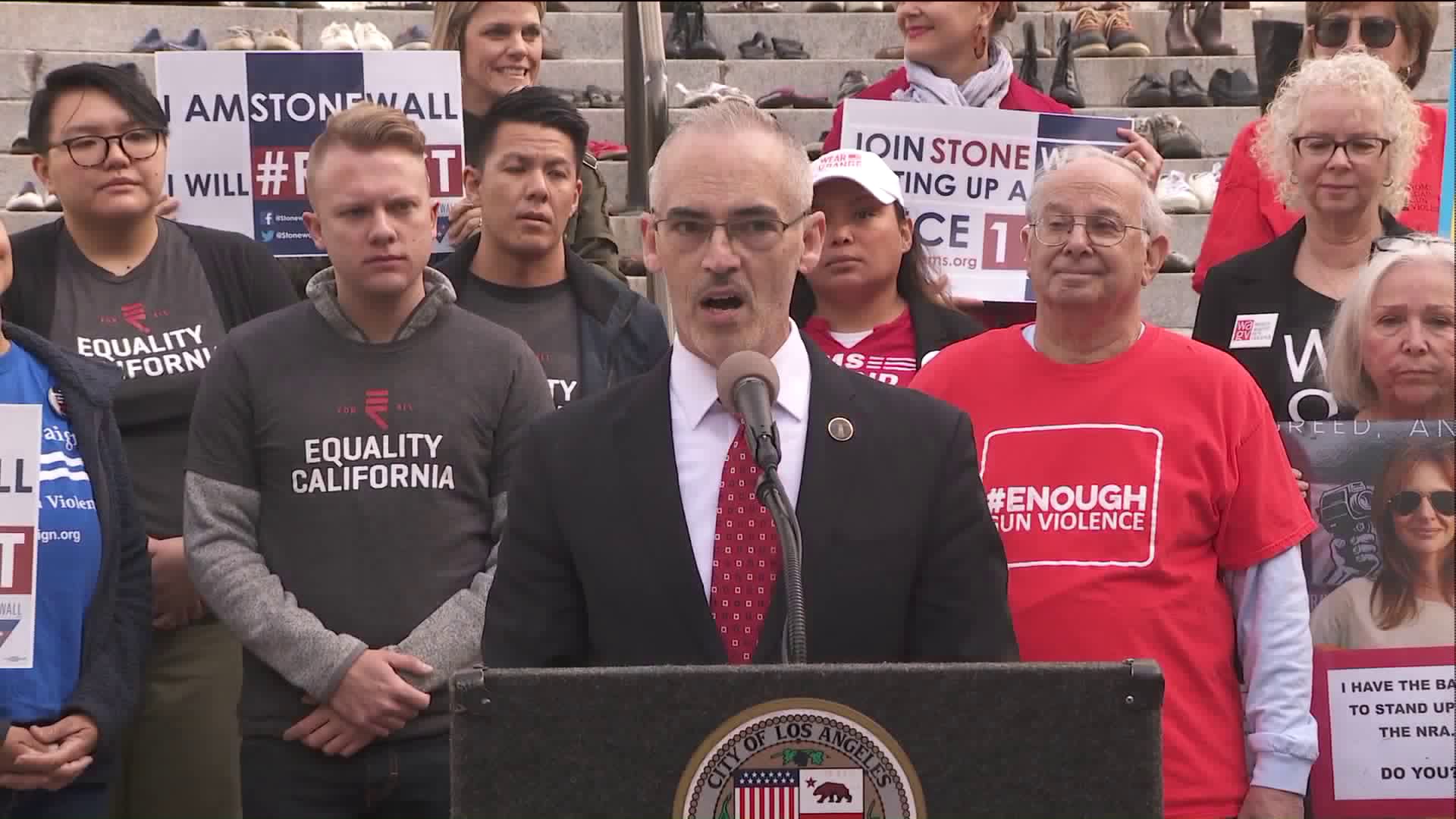 Anti-gun violence advocates stand behind Councilman Mitch O'Farrell at a news conference at City Hall in downtown Los Angeles on Feb. 12, 2019. (Credit: KTLA)