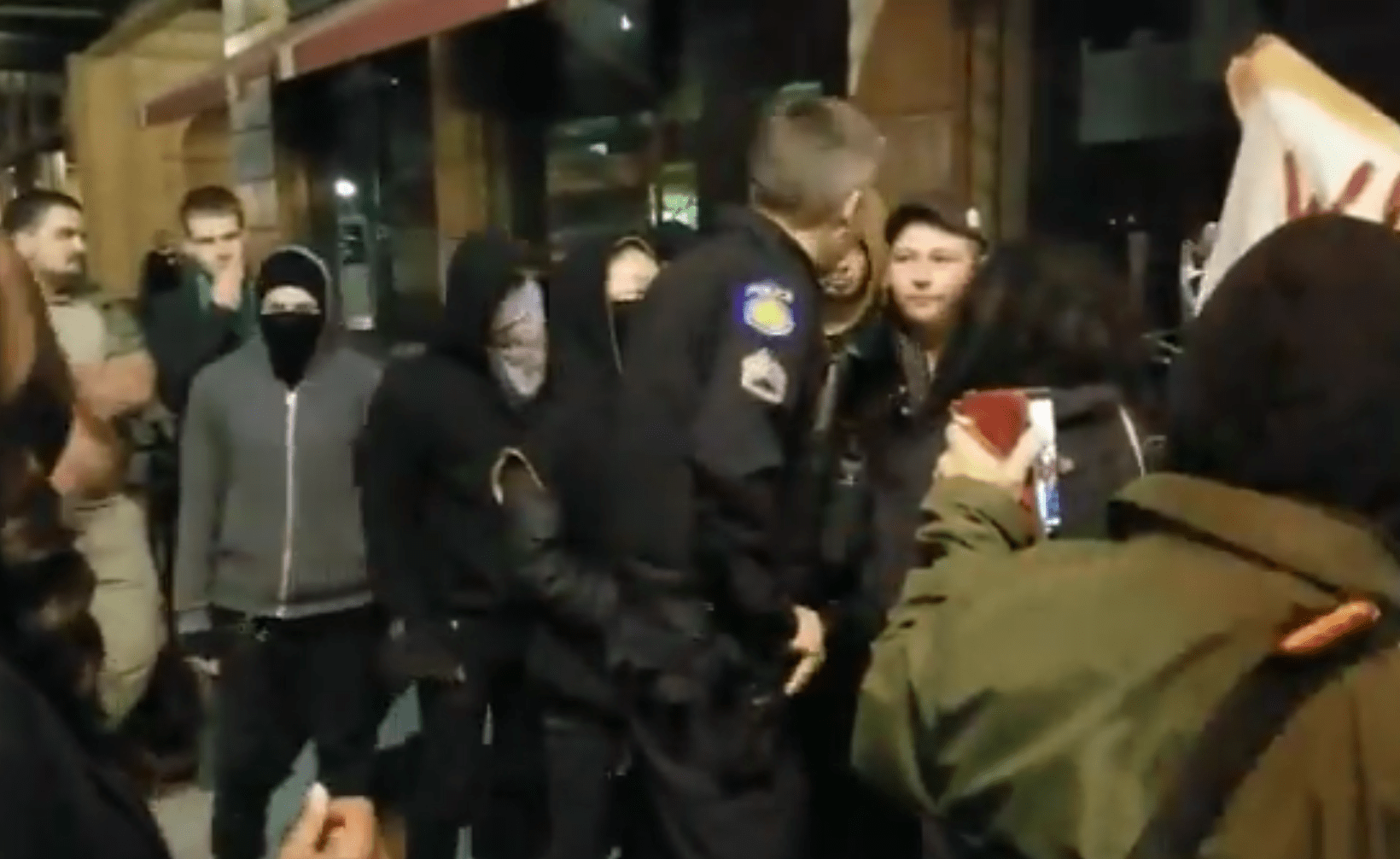 Police break up a confrontation outside a "Build the Wall" dinner in Sacramento on Feb. 23, 2019. (Credit: Christine Mai-Duc/Los Angeles Times)