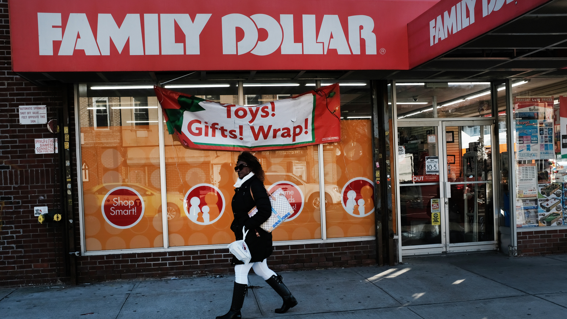 A woman walks by a Family Dollar store on December 11, 2018 in the Brooklyn borough of New York City. (Credit: Spencer Platt/Getty Images)