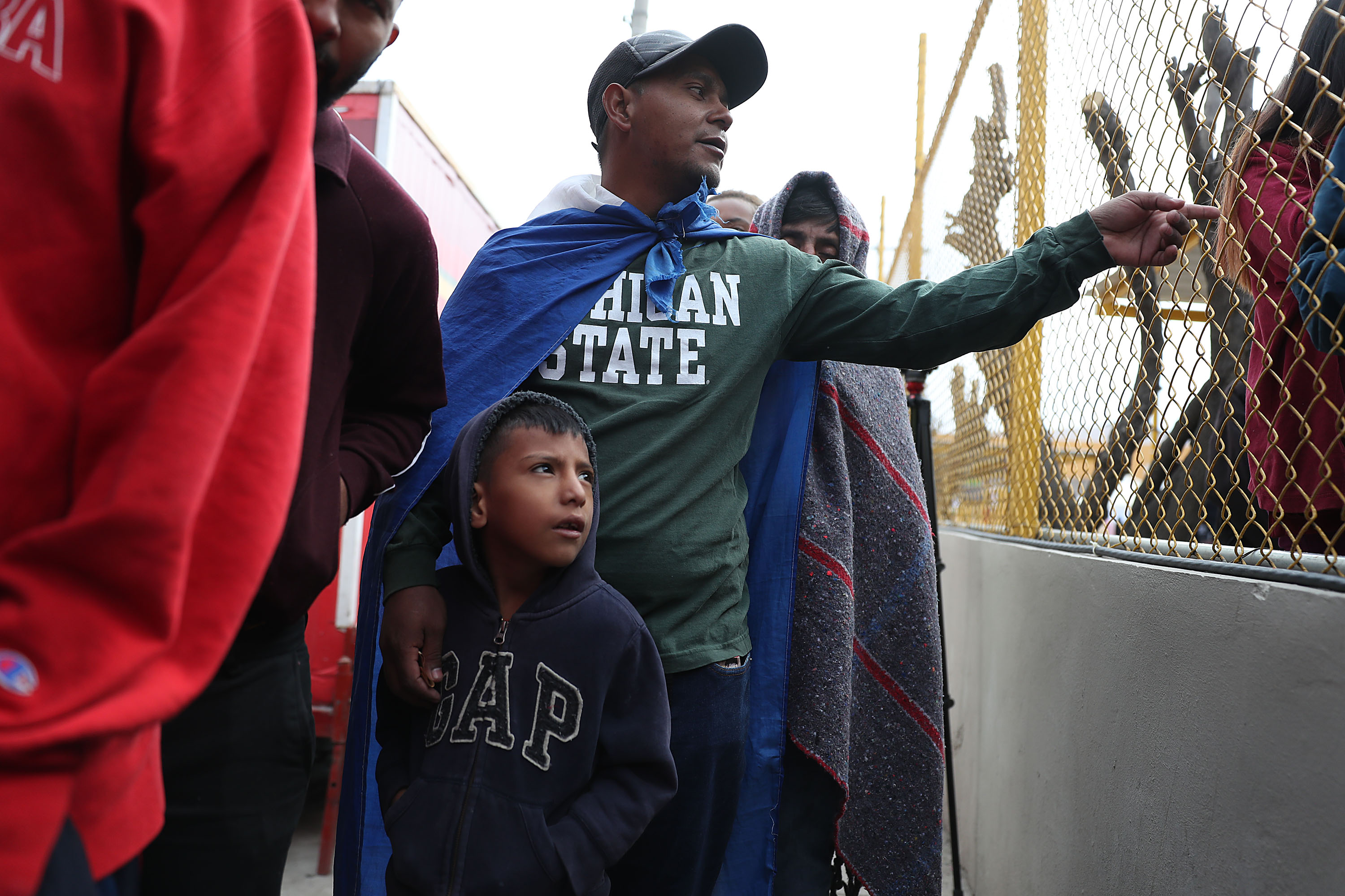 Jose Martinez and his son, Jonathan Martinez, both of whom are from Honduras, join other migrants, most of whom are part of a recently arrived caravan, at a migrant hostel in Piedras Negras, Mexico, as they wait to apply for asylum in to the United States on Feb. 9, 2019. (Credit: Joe Raedle / Getty Images)