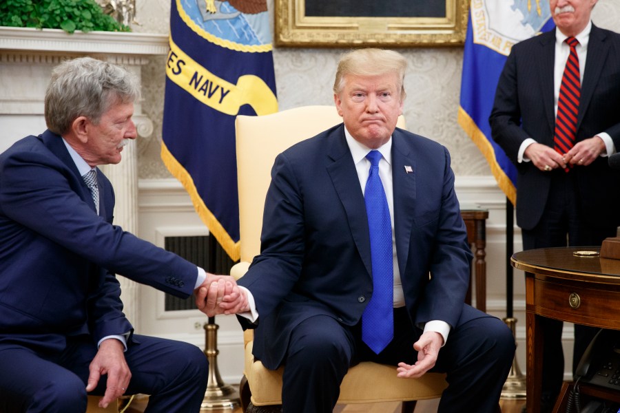 Danny Burch, left, a former U.S. hostage in Yemen, shakes hands with President Donald Trump inside the Oval Office on March 6, 2019. (Credit: Tom Brenner / Getty Images)