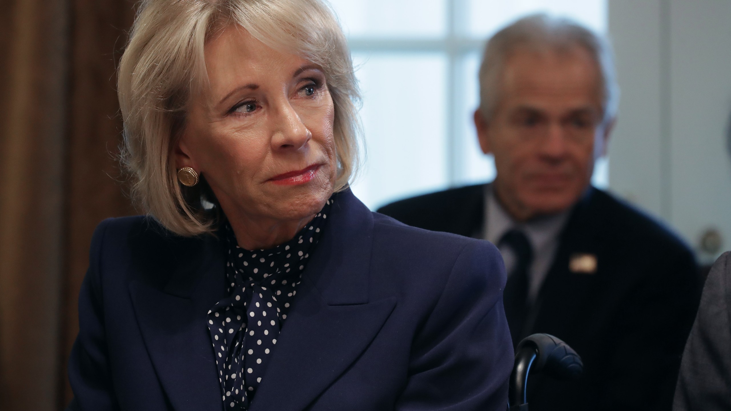 Education Secretary Betsy DeVos listens to U.S. President Donald Trump talk to reporters during a cabinet meeting in the Cabinet Room at the White House Feb. 12, 2019, in Washington, D.C. (Credit: Chip Somodevilla/Getty Images)