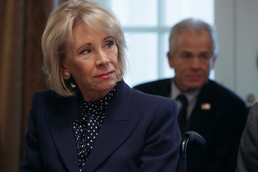 Education Secretary Betsy DeVos listens to U.S. President Donald Trump talk to reporters during a cabinet meeting in the Cabinet Room at the White House Feb. 12, 2019, in Washington, D.C. (Credit: Chip Somodevilla/Getty Images)