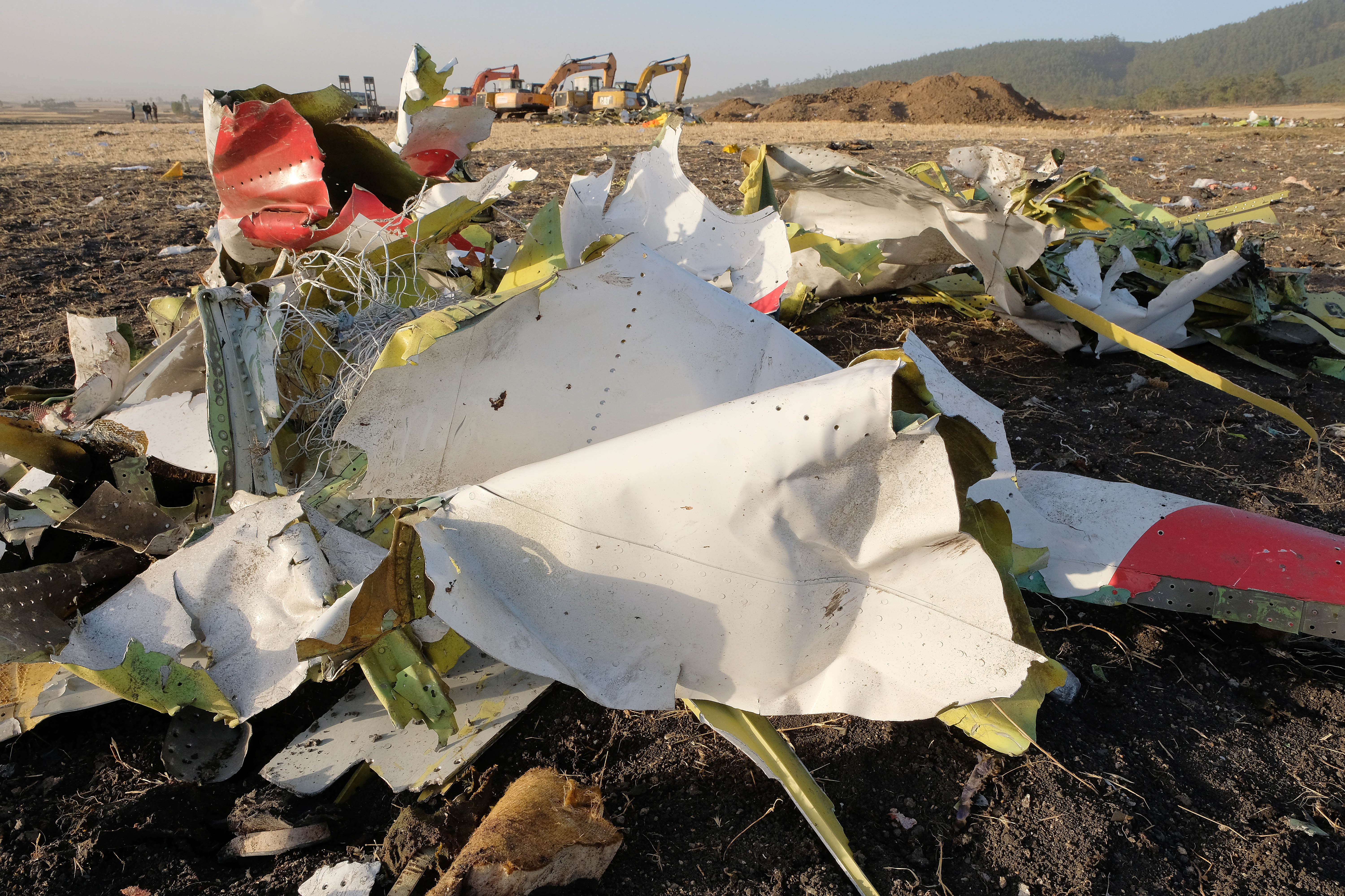 Debris lays piled up just outside the impact crater after being gathered by workers during the continuing recovery efforts at the crash site of Ethiopian Airlines flight ET302 on March 11, 2019 in Bishoftu, Ethiopia. (Credit: Jemal Countess/Getty Images)