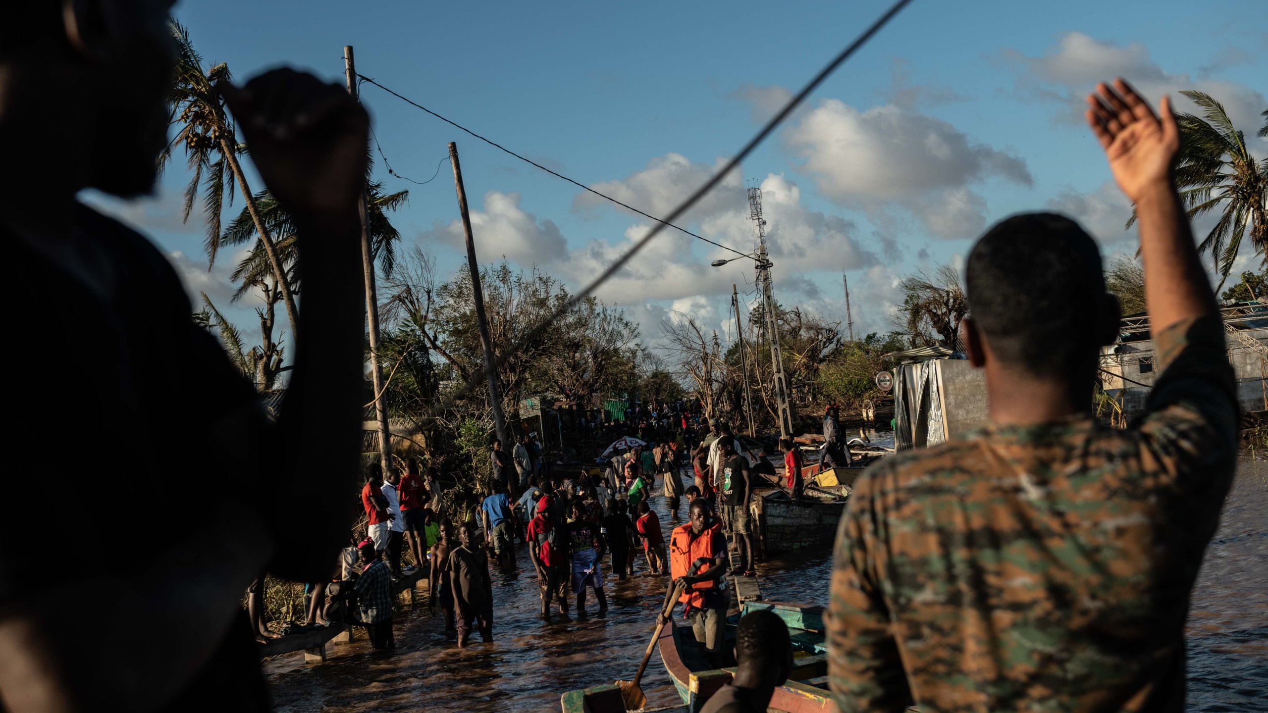 People stranded by Cyclone Idai wait for rescue by the Indian Navy on March 22, 2019 in Buzi, Mozambique. Thousands of people are still stranded after after the storm hit the country last week. (Credit: Andrew Renneisen/Getty Images)