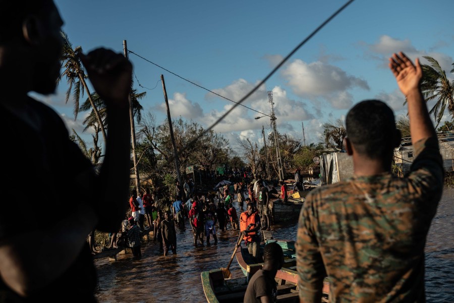 People stranded by Cyclone Idai wait for rescue by the Indian Navy on March 22, 2019 in Buzi, Mozambique. Thousands of people are still stranded after after the storm hit the country last week. (Credit: Andrew Renneisen/Getty Images)