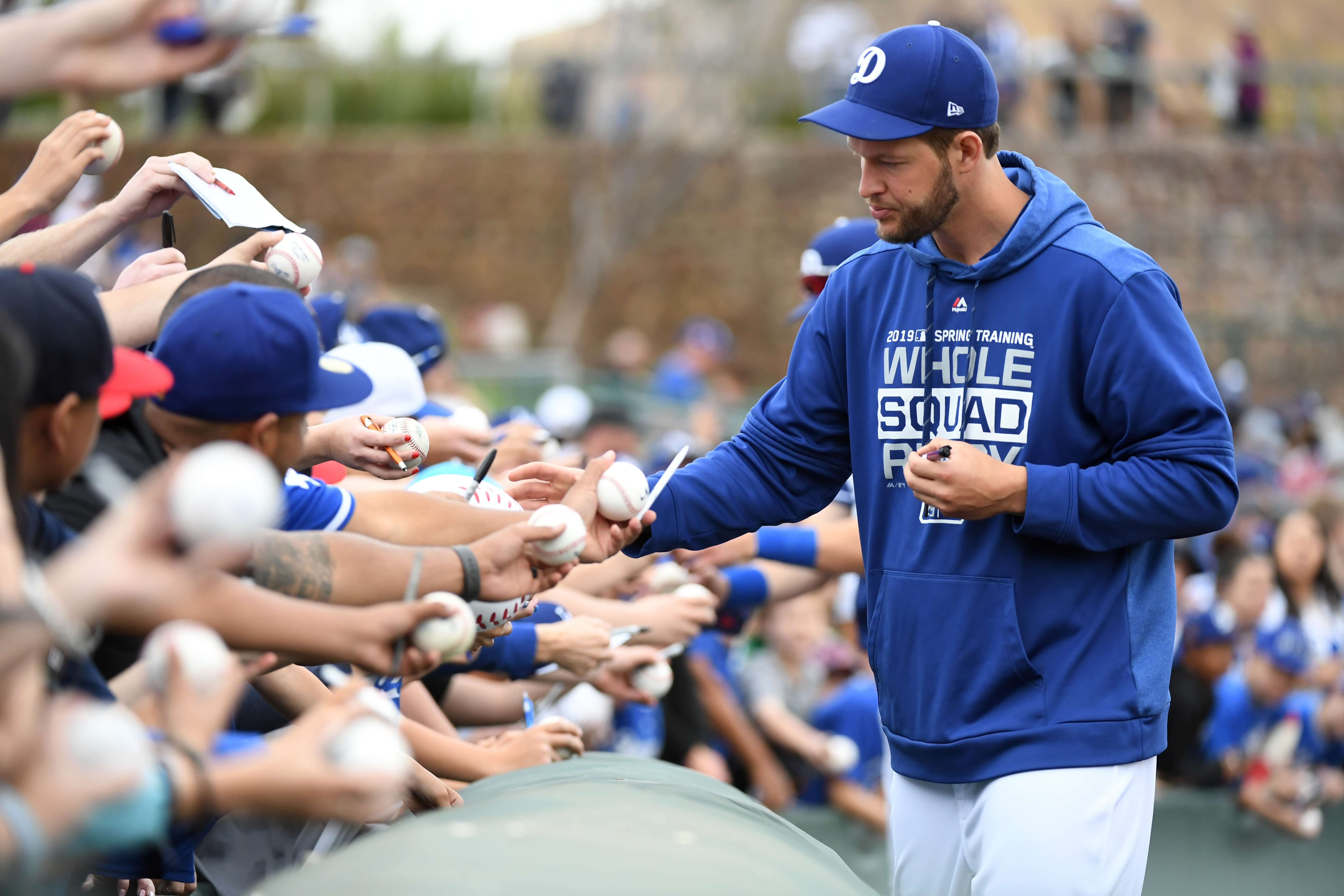 Clayton Kershaw signs autographs before a spring training game against the San Francisco Giants at Camelback Ranch on March 11, 2019 in Glendale, Arizona. (Credit: Norm Hall/Getty Images)