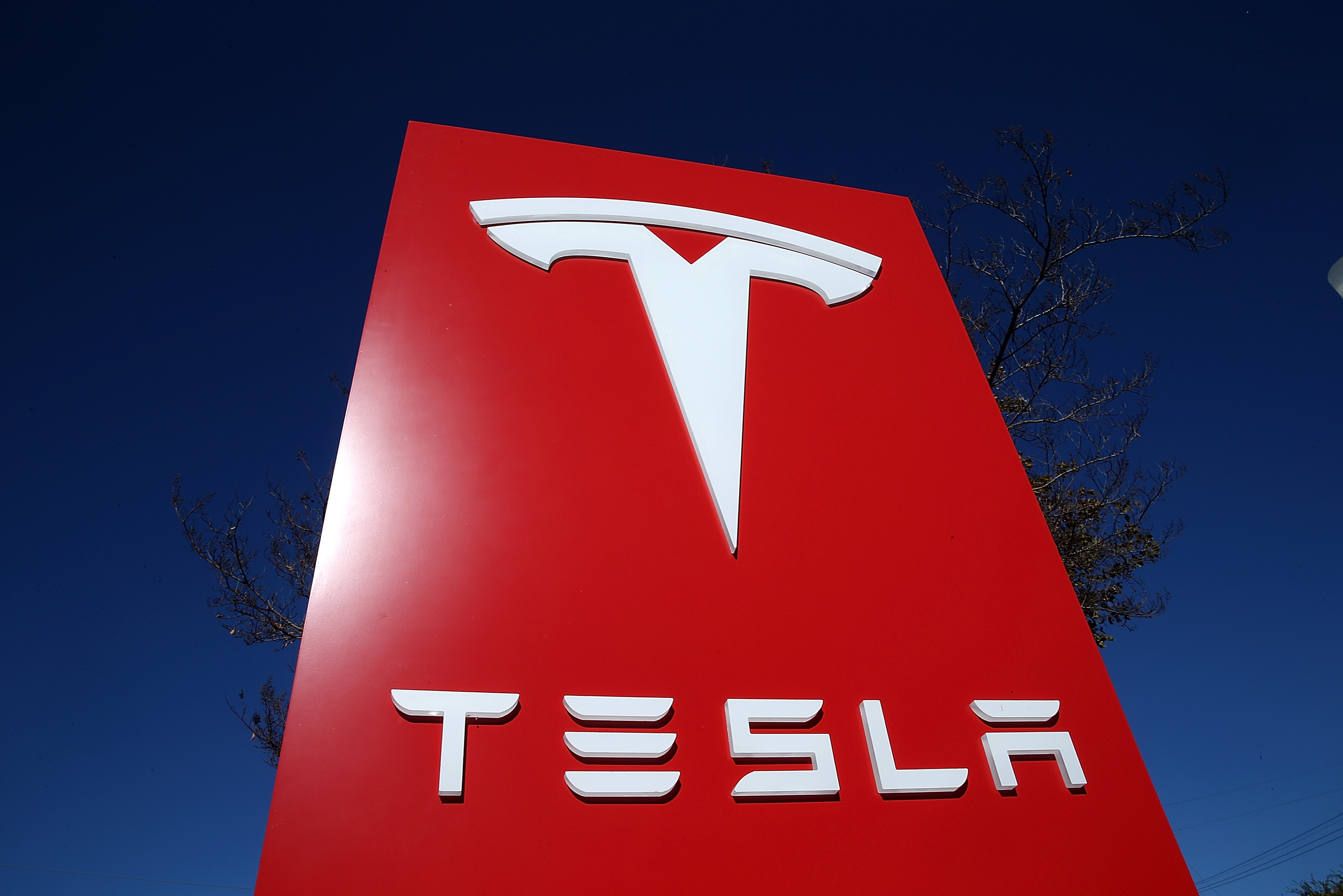 A sign is posted at a Tesla showroom on November 5, 2013 in Palo Alto, California. (Credit: Justin Sullivan/Getty Images)