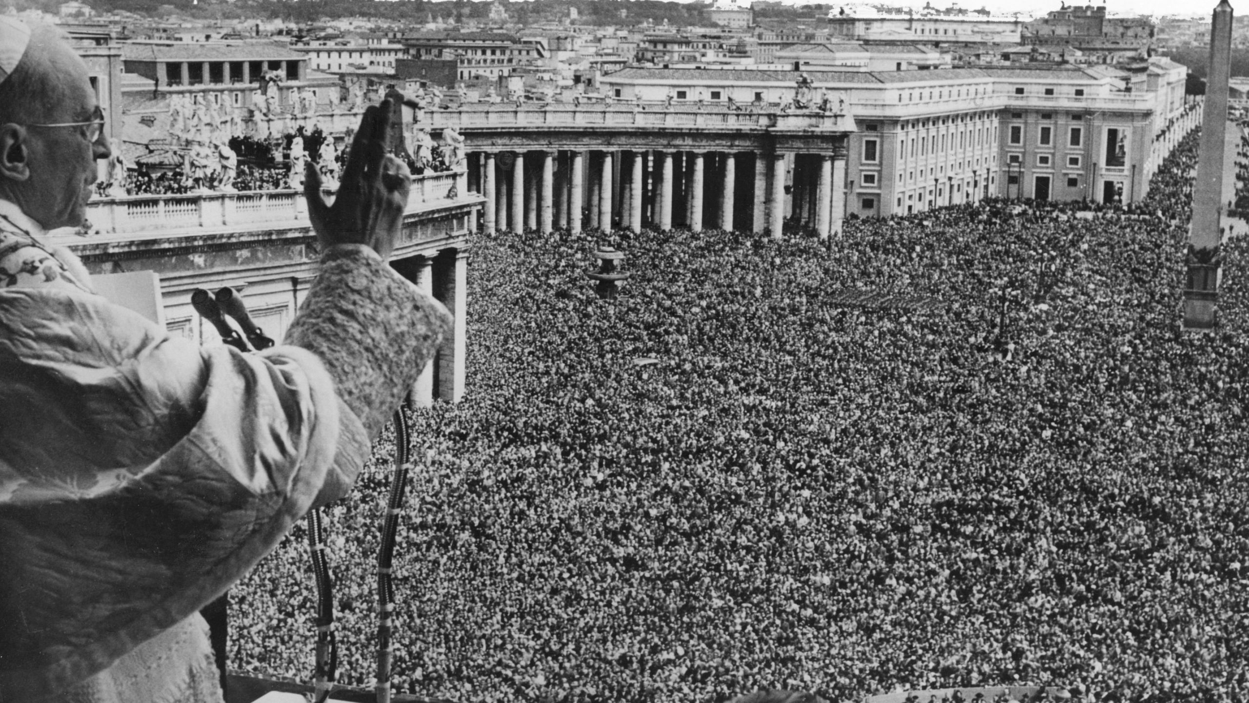 Pope Pius XII blessing the vast crowd gathered in St Peter's Square to witness his appearance on the Vatican balcony. (Credit: Fox Photos/Getty Images)