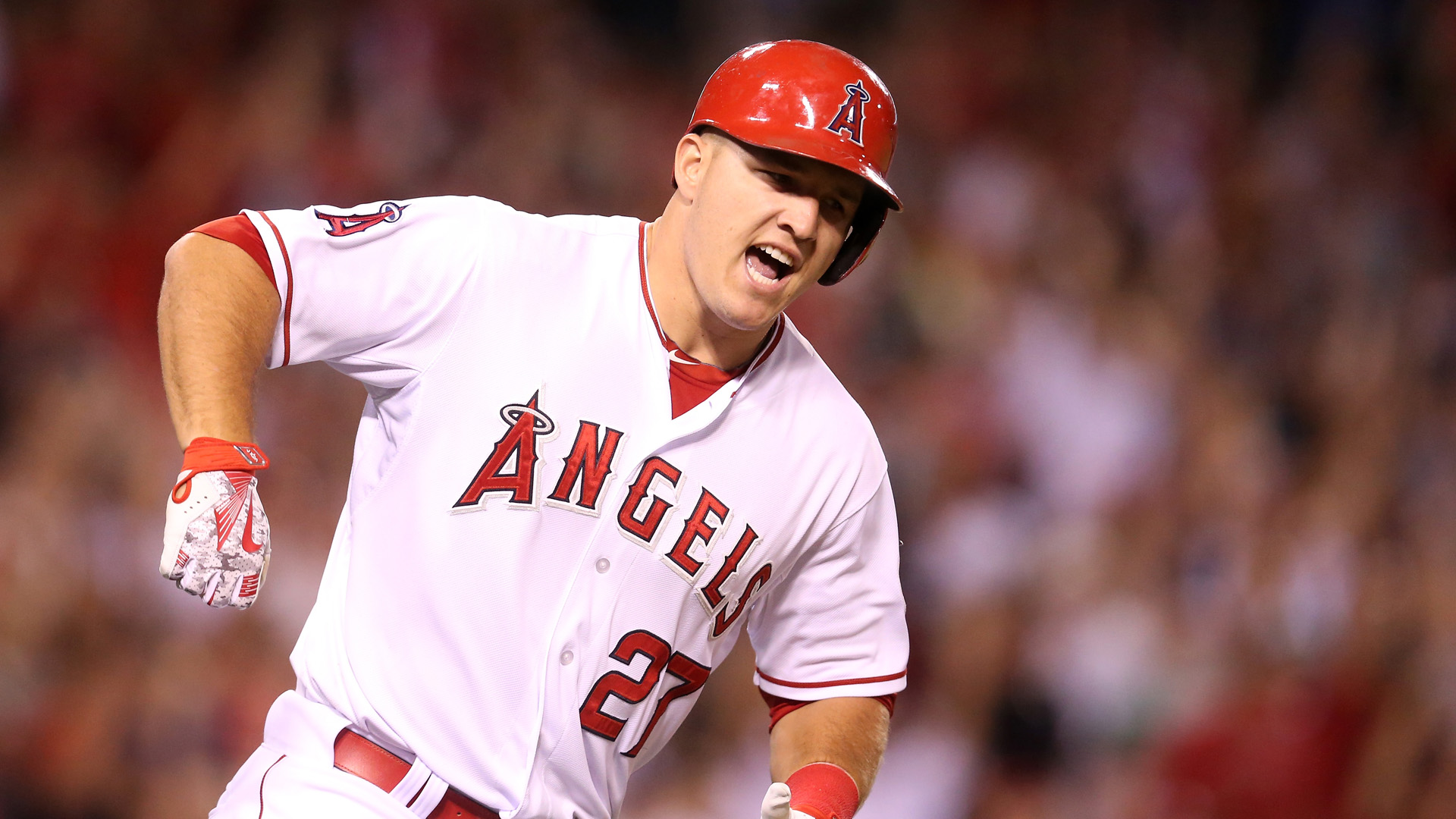 Mike Trout reacts as he runs to first as his walk off home run clears the wall in the ninth inning against the Boston Red Sox at Angel Stadium of Anaheim on July 17, 2015 in Anaheim, California. (Credit: Stephen Dunn/Getty Images)