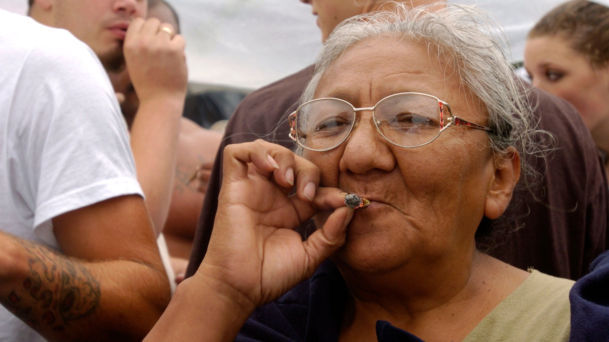 A woman smokes a marijuana joint at Hempfest on Aug. 21, 2004, in Seattle, Washington. (Credit: Ron Wurzer/Getty Images)