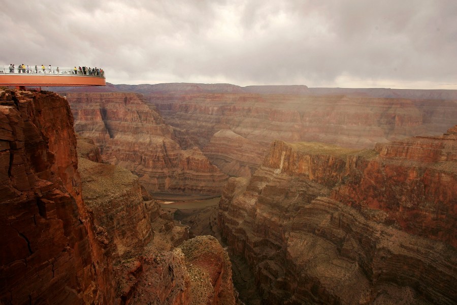 People take the first official walk on the Skywalk, billed as the first-ever cantilever-shaped glass walkway, extending 70 feet from the western Grand Canyon's rim more than 4,000 feet above the Colorado River, on March 20, 2007. (Credit: David McNew / Getty Images)