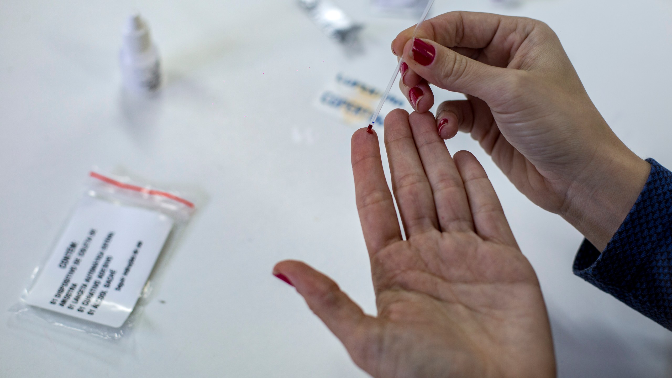 A woman shows how an HIV self-test kit works in Rio de Janeiro, Brazil on July 07, 2017.(Credit: MAURO PIMENTEL/AFP/Getty Images)