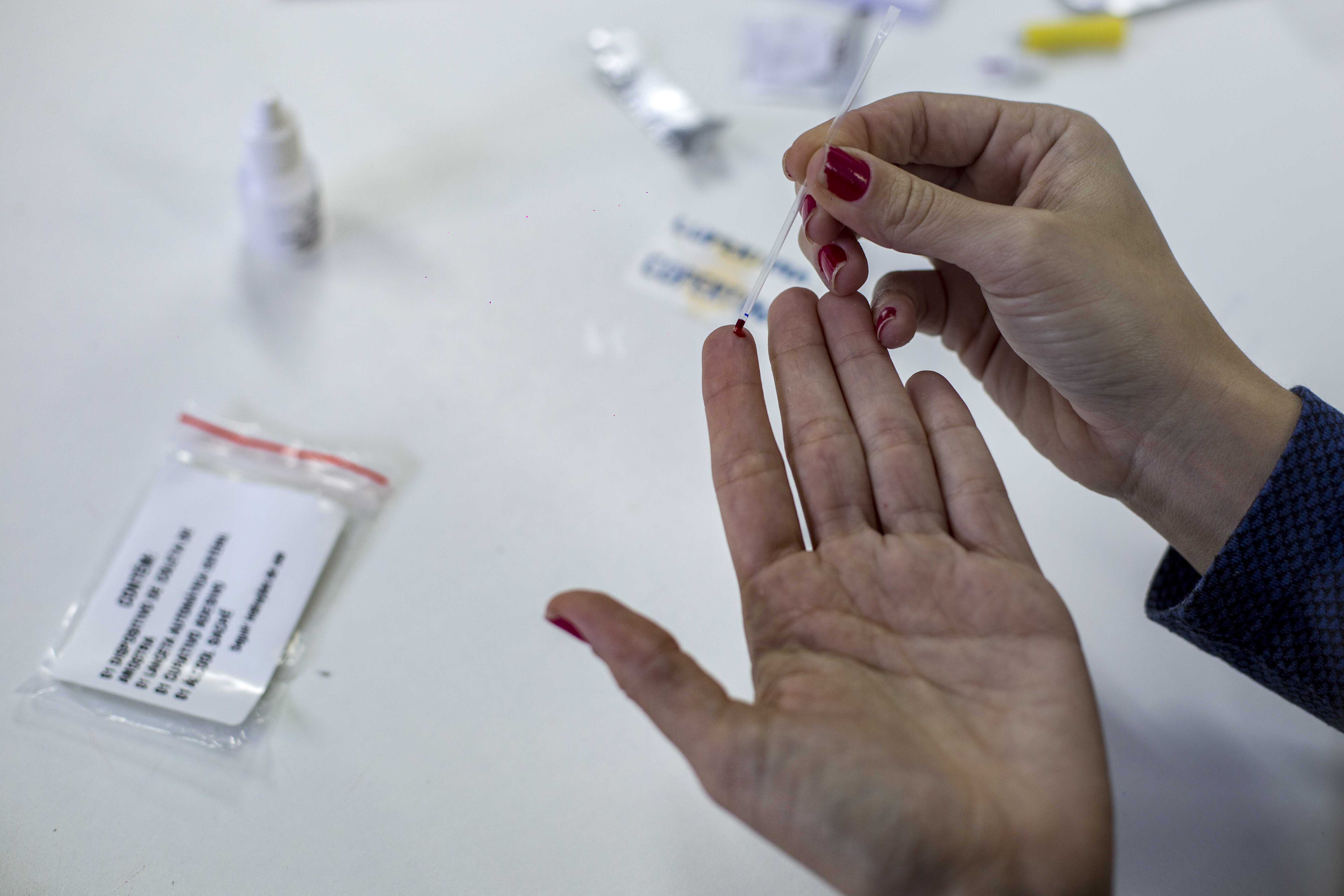 A woman shows how an HIV self-test kit works in Rio de Janeiro, Brazil on July 07, 2017.(Credit: MAURO PIMENTEL/AFP/Getty Images)