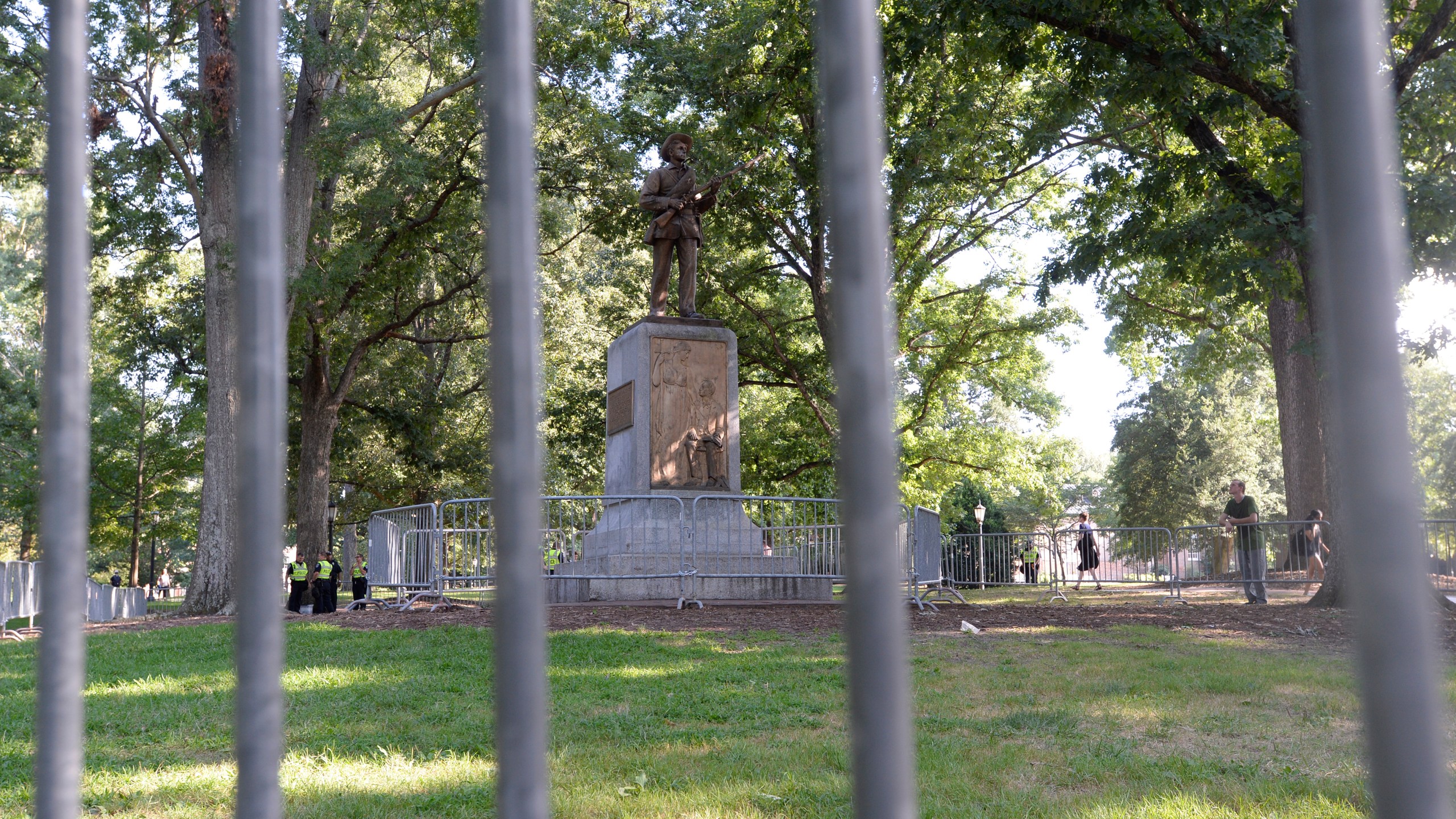 A Confederate statue, coined Silent Sam, is guarded by two layers of fence, chain and police on the campus of the University of North Carolina at Chapel Hill on Aug. 22, 2017. (Credit: Sara D. Davis / Getty Images)