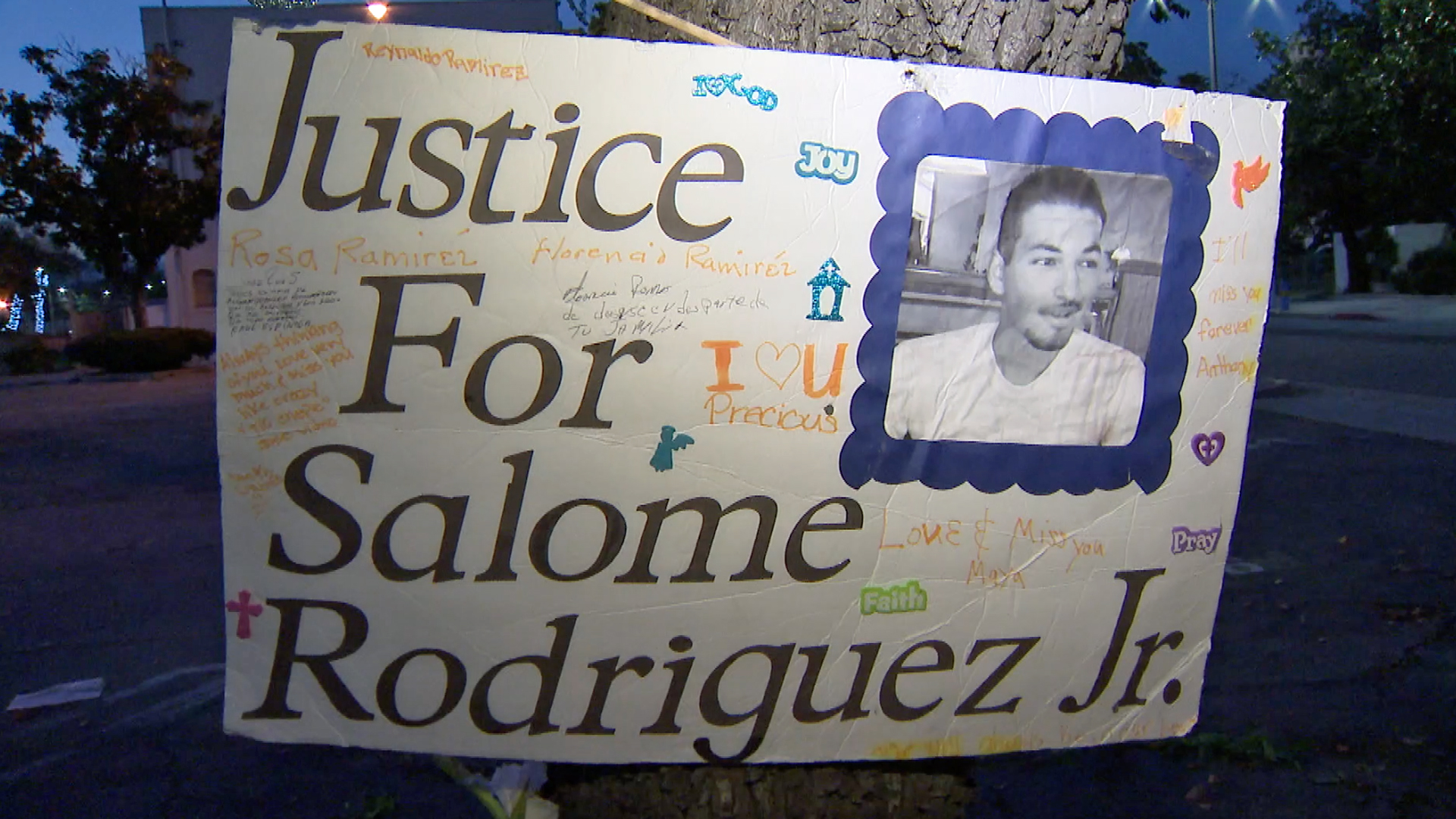 A poster for Salome Rodriguez Jr. is displayed during a vigil on March 13, 2019, the fourth anniversary of his death in Pomona. (Credit: KTLA)