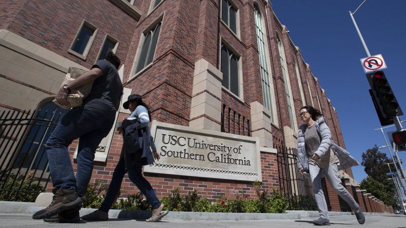 Students walk by a sign for the University of Southern California in an undated image. (Credit: Allen J. Schaben / Los Angeles Times)