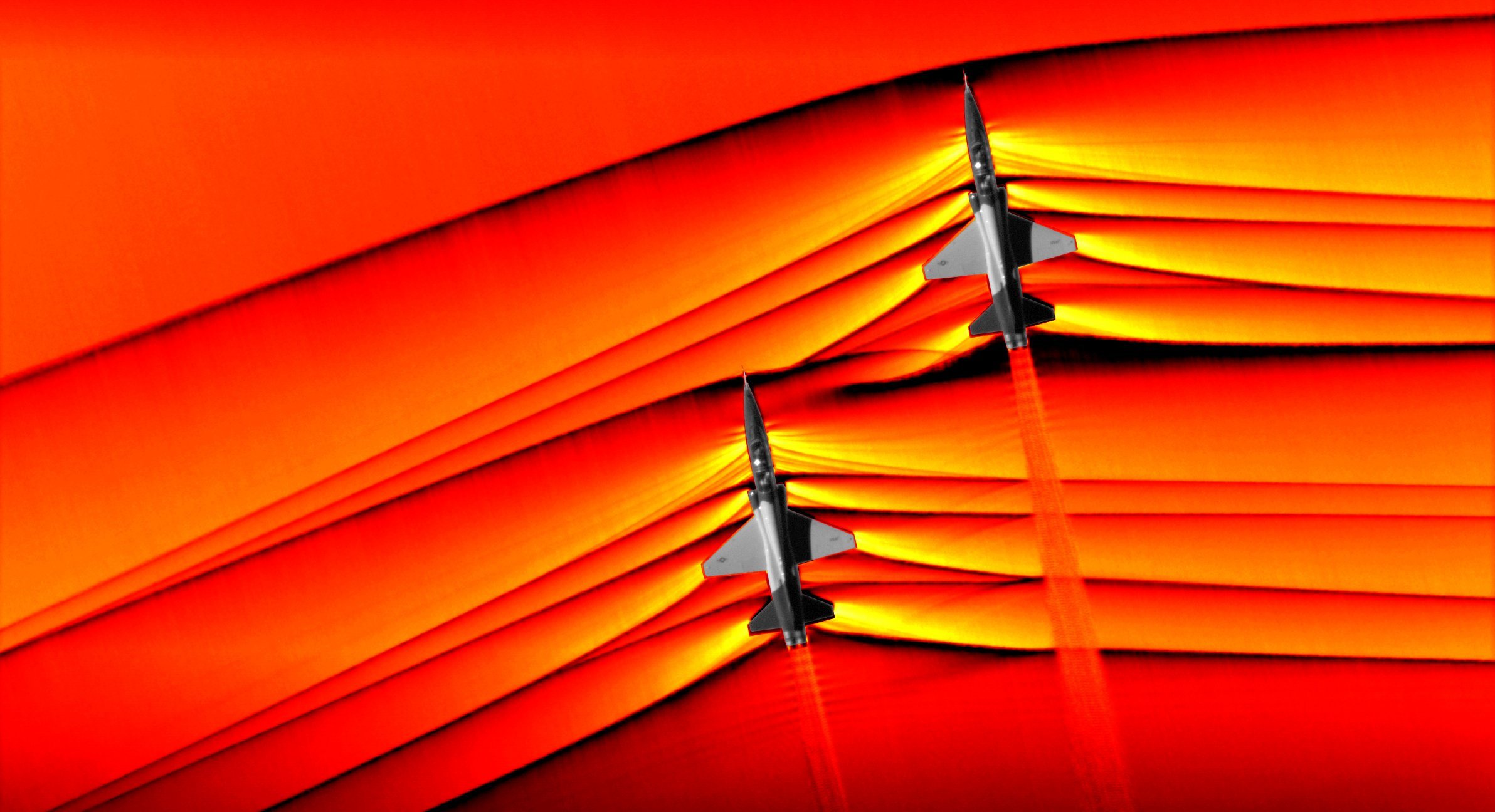 NASA captured the first ever air-to-air images of shock waves interacting from two supersonic T-38 US Air Force jets. (Credit: NASA)