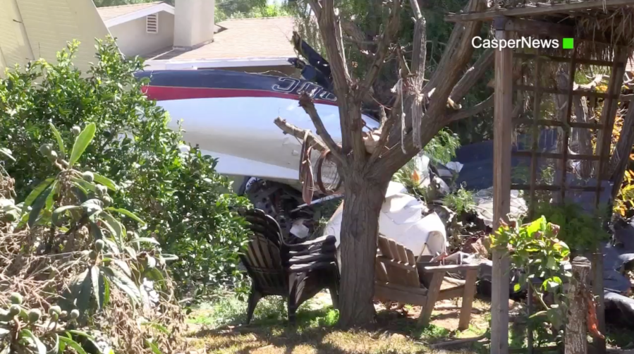 A small plane in a home's yard after crashing into a residential neighborhood in Riverside on March 16, 2019. (Credit: CasperNews)