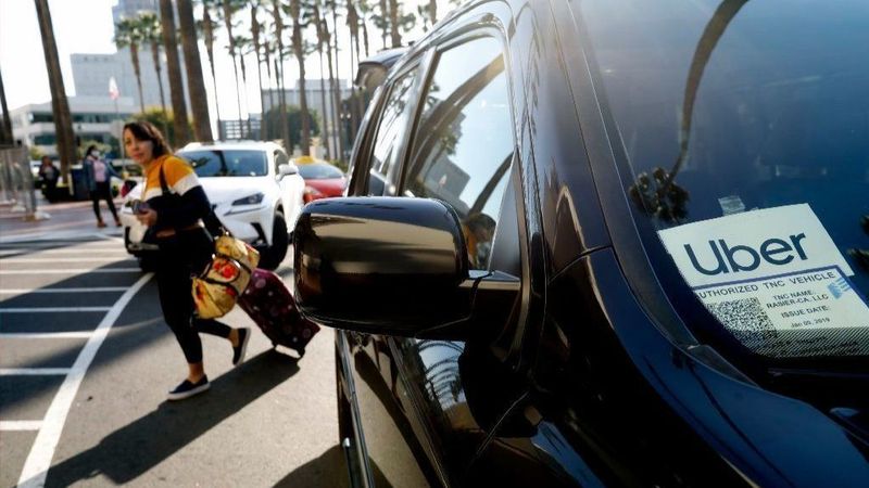 A passenger exits an Uber car at Union Station in Los Angeles in an undated image. (Credit: Francine Orr / Los Angeles Times)