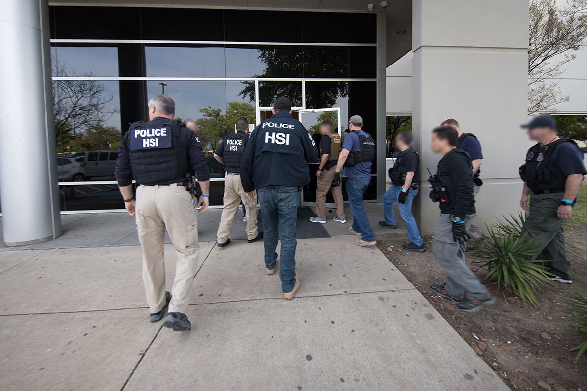 Special agents with U.S. Immigration and Customs Enforcement serve search warrants at CVE Technology Group in Allen, Texas, on April 4, 2019, in an image released by the agency.