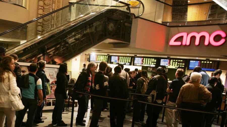 In this file photo, fans wait in line to buy tickets at an AMC theater in New York. (Credit: Chris Hondros/Getty Images)