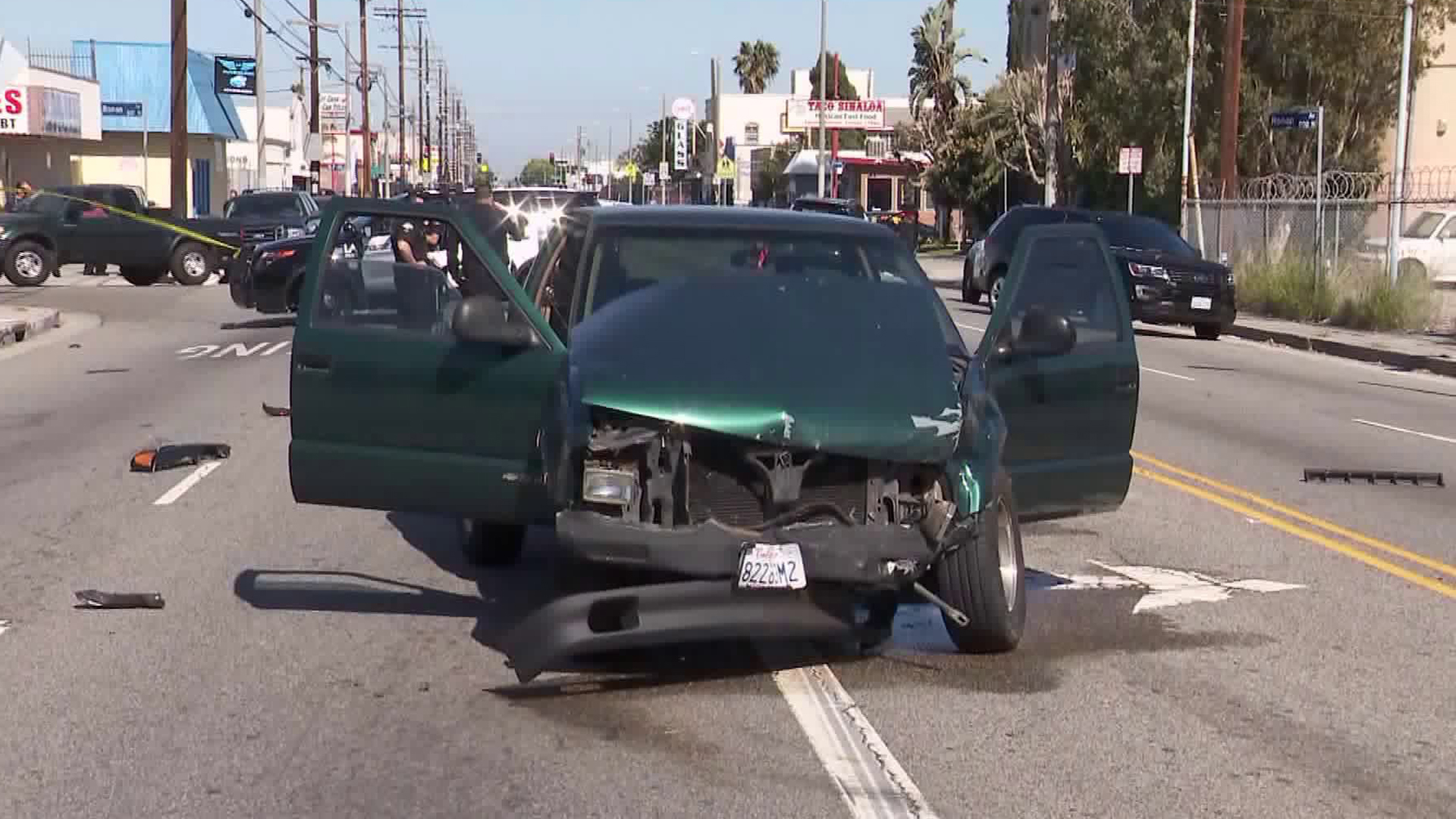 The suspect's green pickup truck is seen after a it-and-run collision in Wilmington on April 17, 2019. (Credit: KTLA)