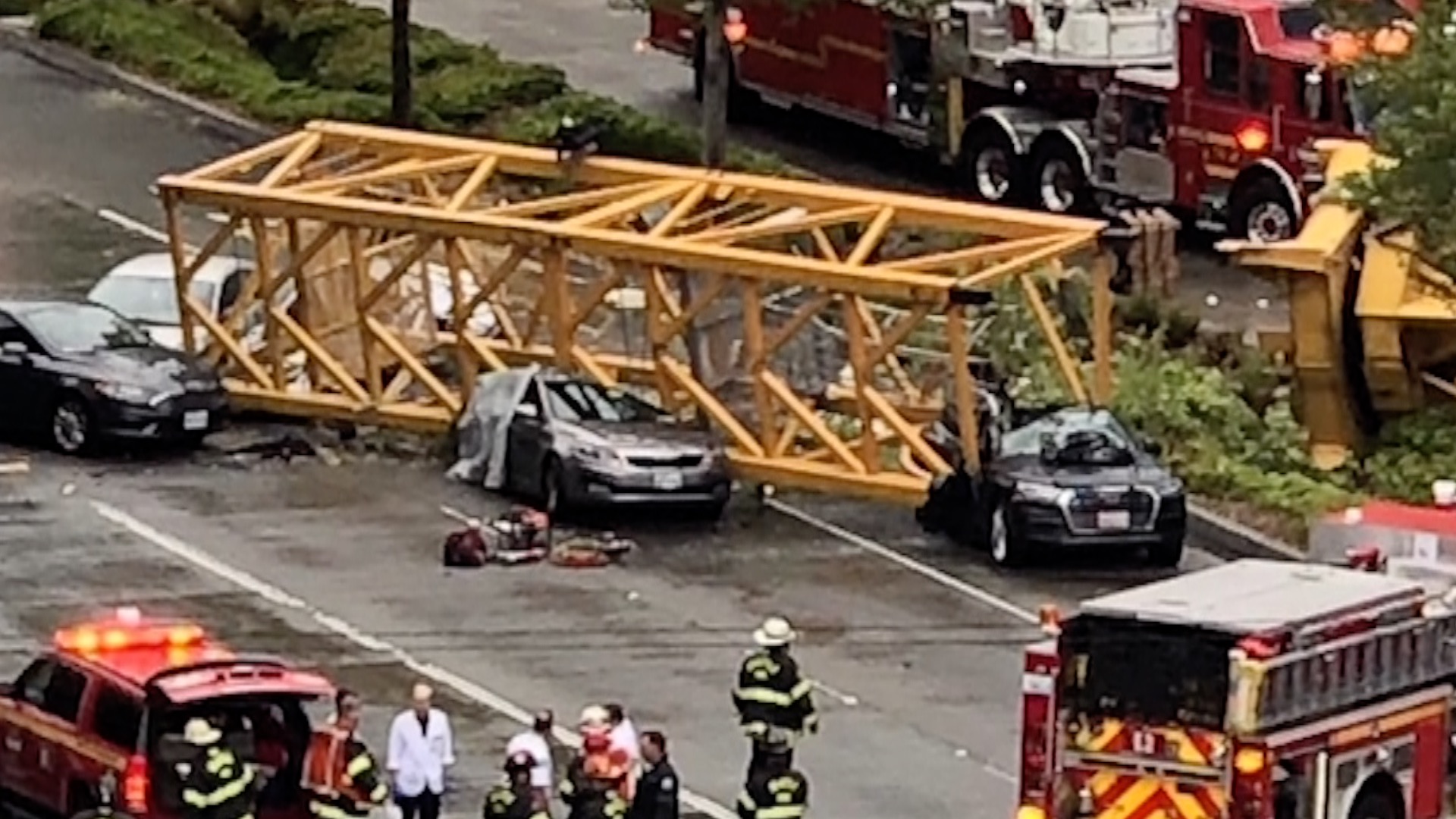 Cars are seen crushed under a construction crane in downtown Seattle. (Credit: Morgan Ludlow via CNN)