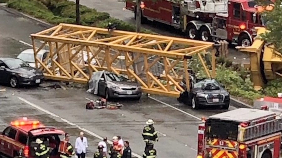 Cars are seen crushed under a construction crane in downtown Seattle. (Credit: Morgan Ludlow via CNN)