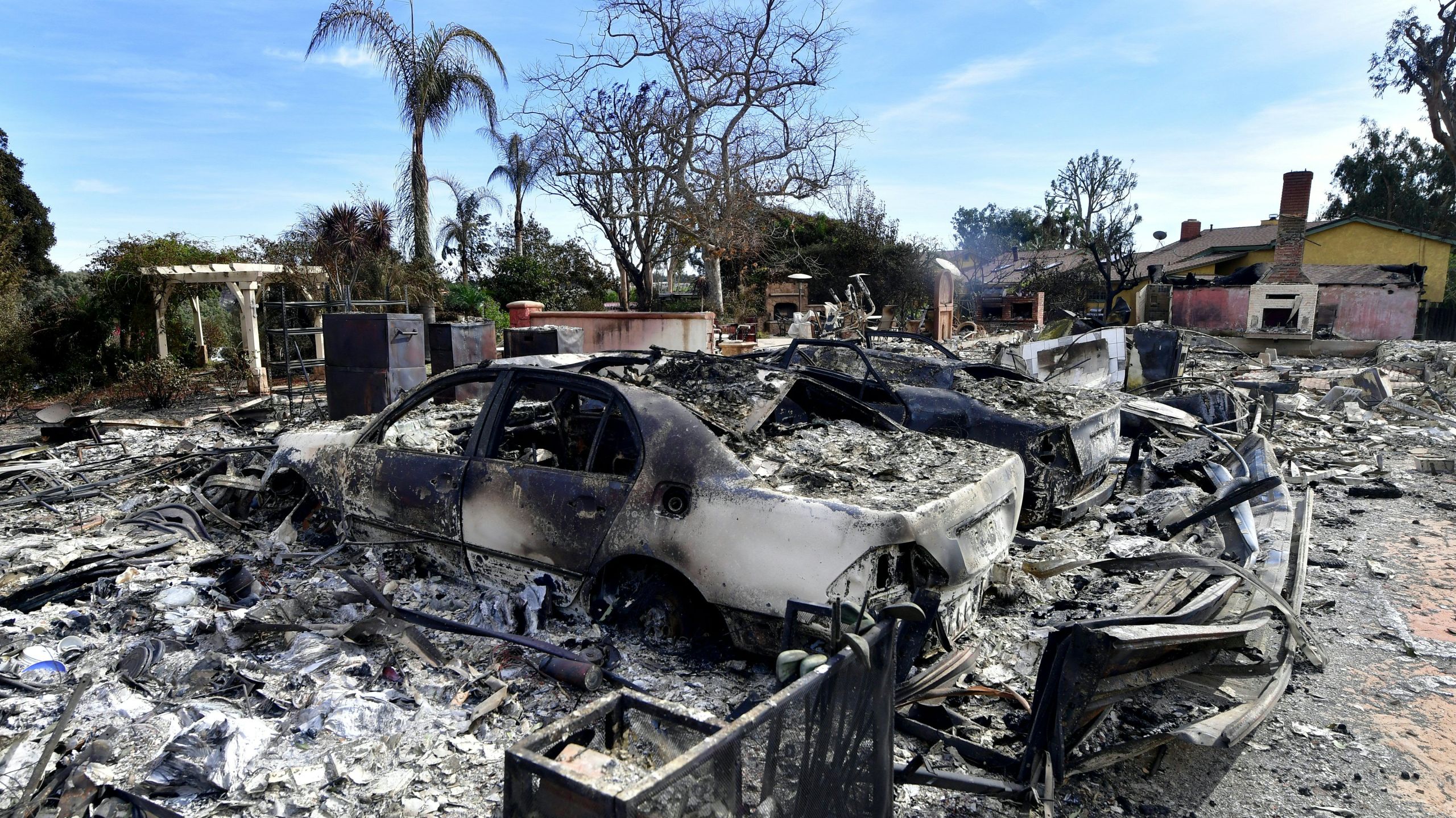 The remains of burnt down homes and vehicles are seen after the Woolsey Fire in Malibu on Nov. 13, 2018. (Credit: FREDERIC J. BROWN/AFP/Getty Images)