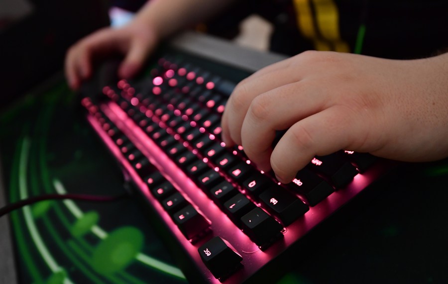 This file photo shows a child using a gaming keyboard. (Credit: Tobias Schwarz/AFP/Getty Images)