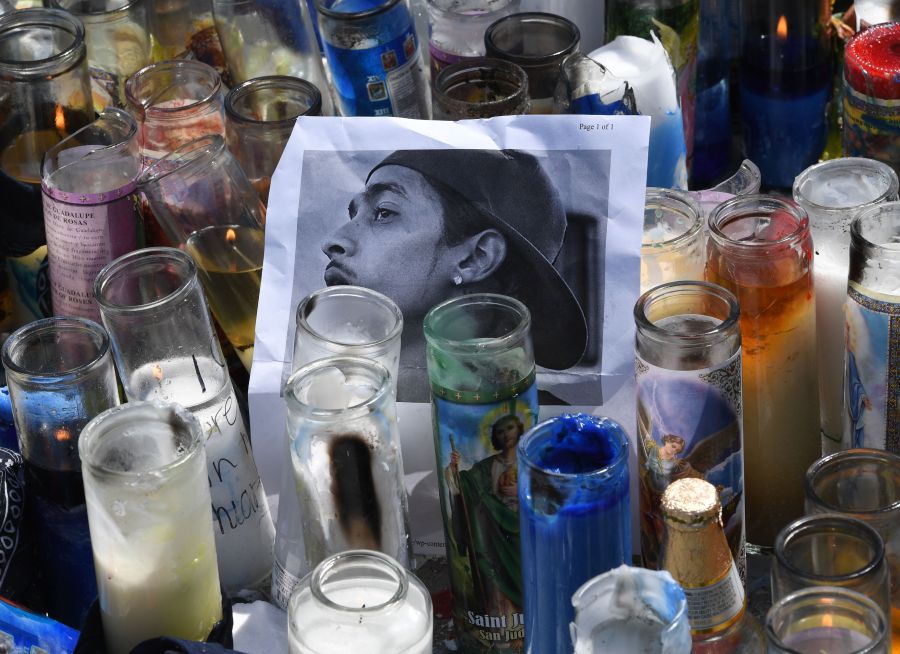 A photo and candles are displayed at a makeshift memorial for Nipsey Hussle on April 1, 2019 outside The Marathon clothing store in South Los Angeles. (Credit: MARK RALSTON/AFP/Getty Images)