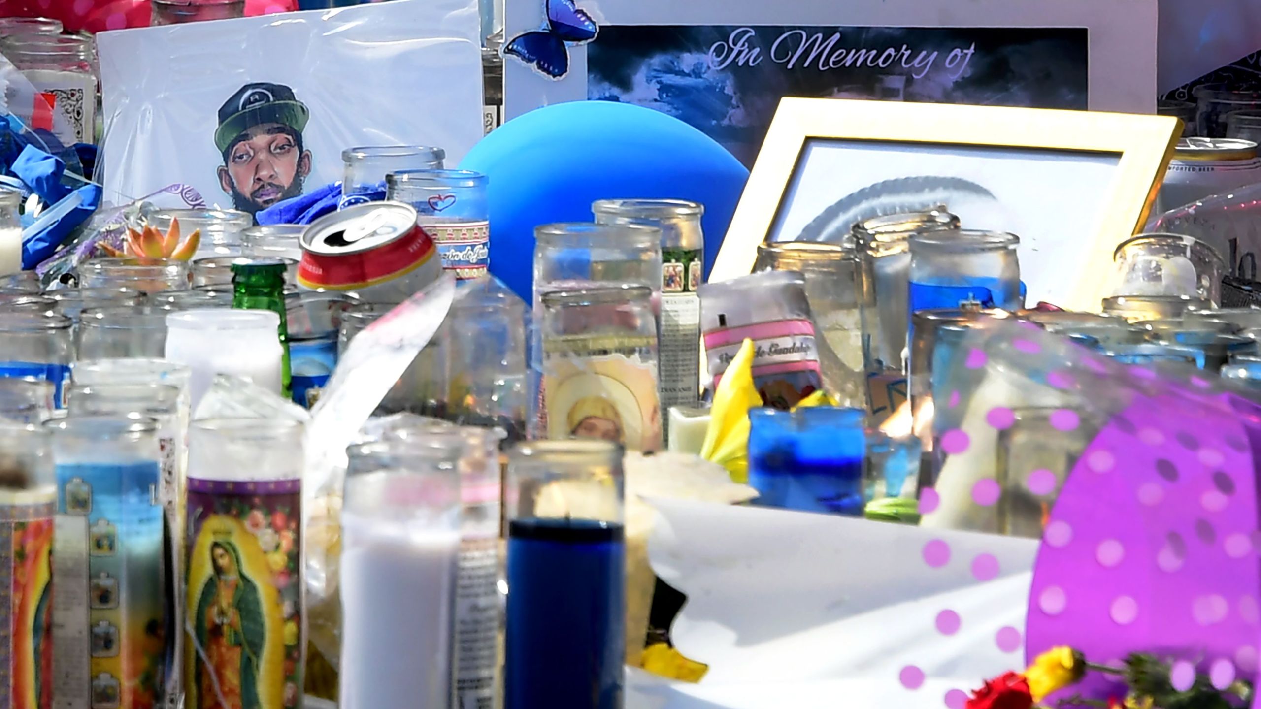 A makeshift memorial for Grammy-nominated rapper Nipsey Hussle sits in the parking lot in front of his Marathon Store in Los Angeles on April 2, 2019. (Credit: FREDERIC J. BROWN/AFP/Getty Images)