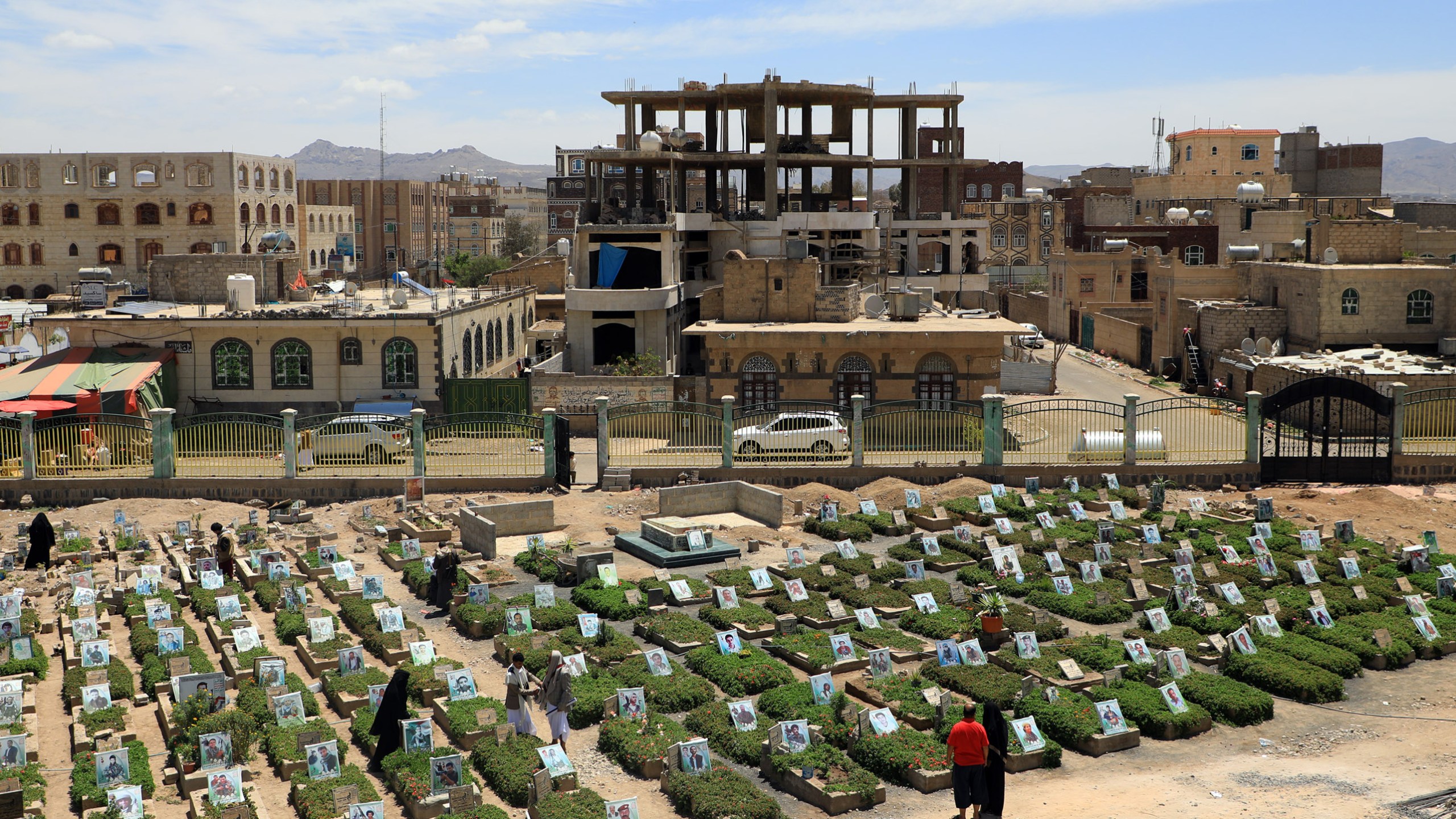 Yemenis visit a cemetery in the capital Sanaa on April 5, 2019. The World Health Organization estimates nearly 10,000 Yemenis have been killed since 2015, when Saudi Arabia and its allies intervened to prevent the defeat of the government in the face of a rebel offensive. (Credit: Mohammed Huwais / AFP / Getty Images)