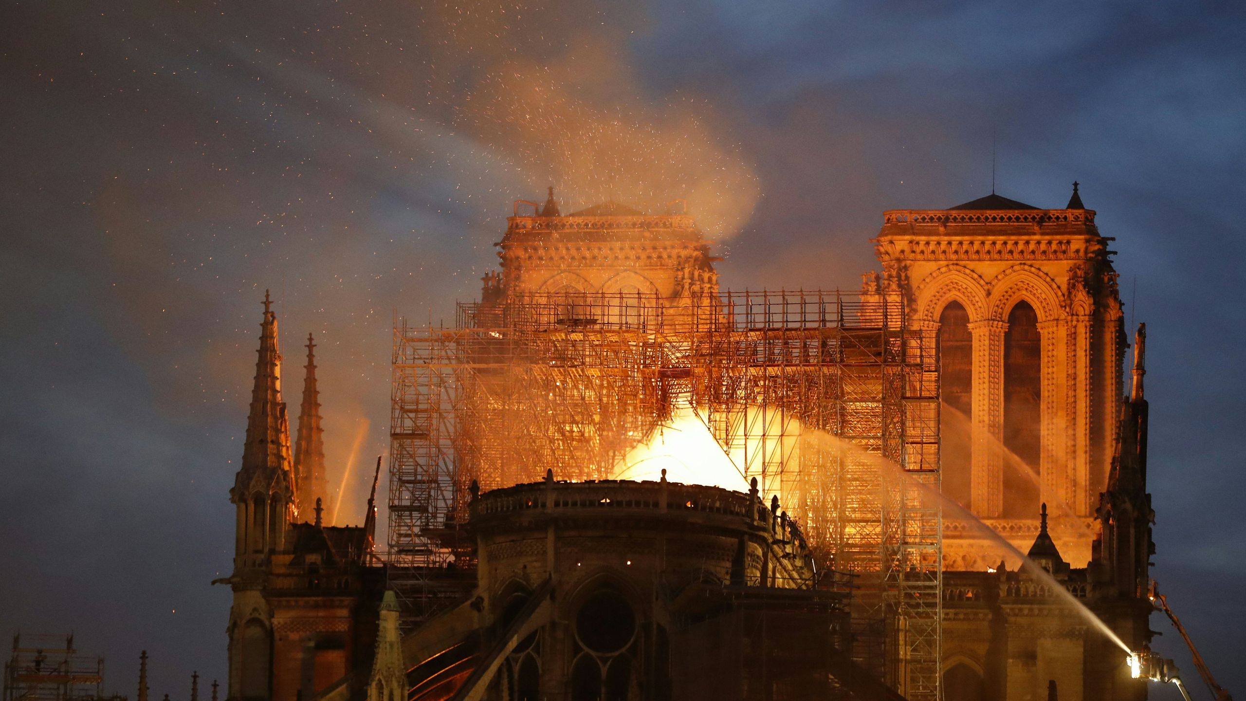 Firefighter douse flames billowing from the roof at Notre-Dame Cathedral in Paris on April 15, 2019. (FRANCOIS GUILLOT/AFP/Getty Images)