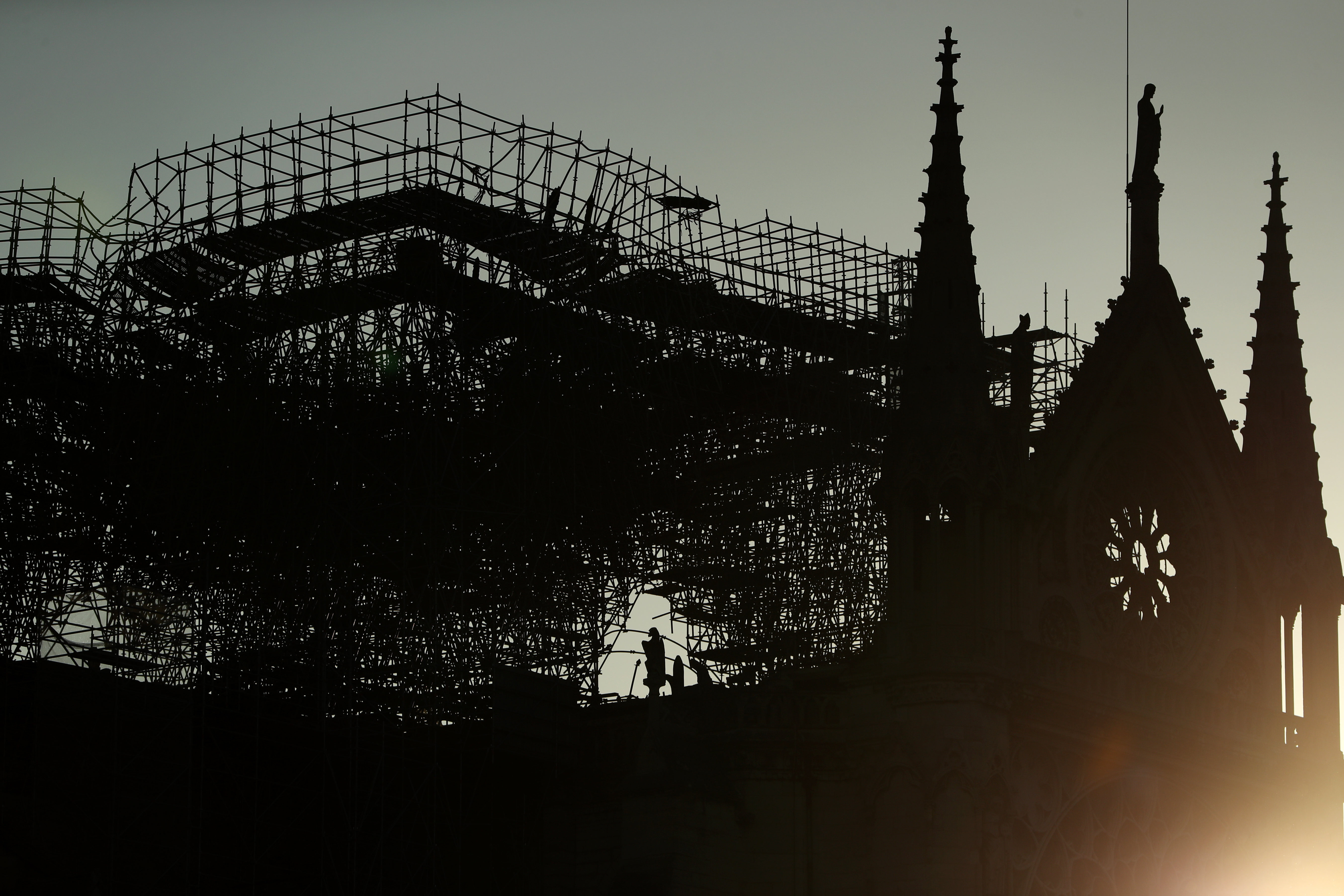 A silhouette of Notre-Dame Cathedral is seen at sunrise following a major fire on Monday on April 17, 2019 in Paris, France. (Credit: Dan Kitwood/Getty Images)