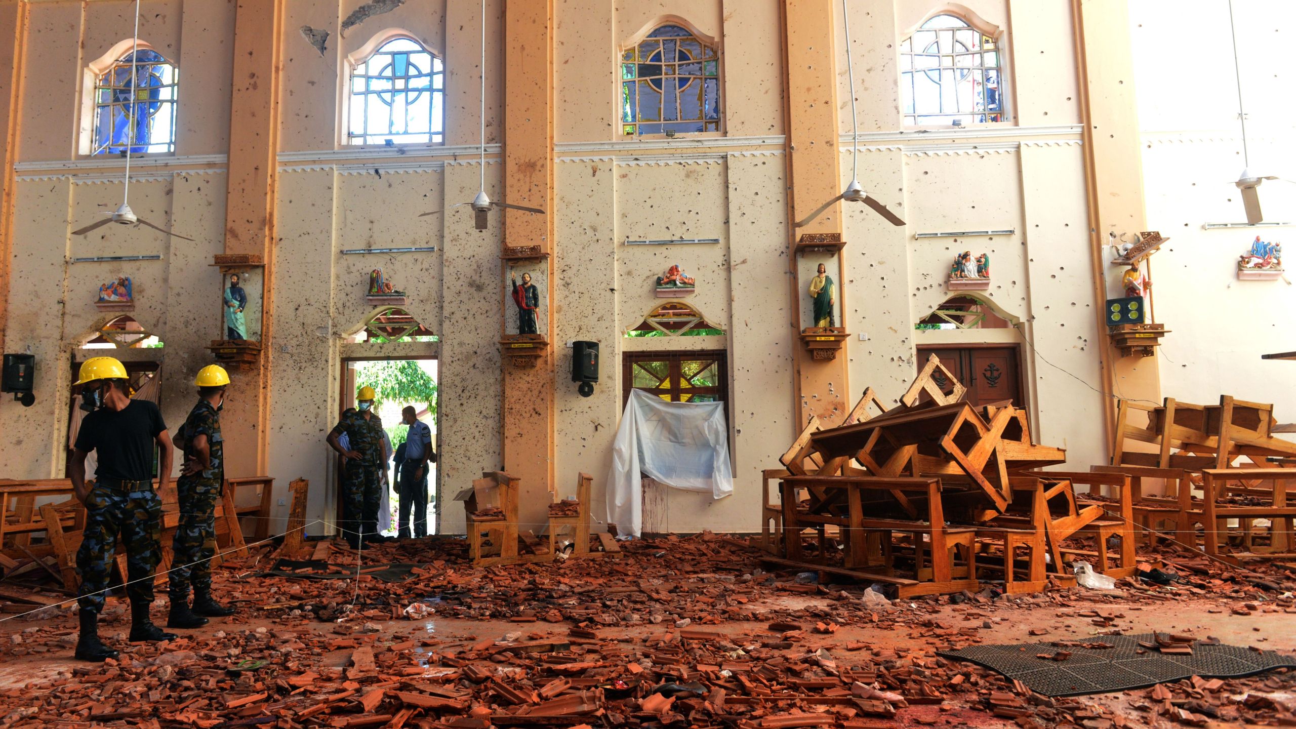 Security personnel inspect the interior of St. Sebastian's Church in Negombo on April 22, 2019. Credit: ISHARA S. KODIKARA/AFP/Getty Images)