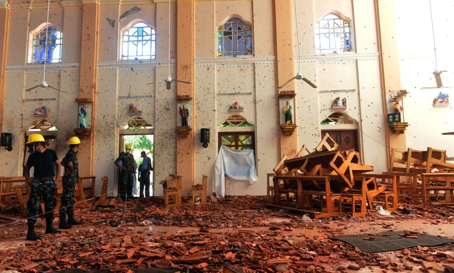 Security personnel inspect the interior of St. Sebastian's Church in Negombo on April 22, 2019. Credit: ISHARA S. KODIKARA/AFP/Getty Images)