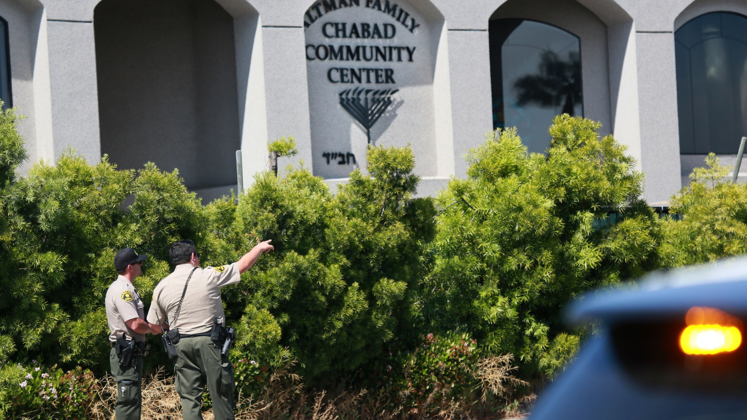 San Diego Sheriff deputies look over the Chabad of Poway Synagogue after a shooting on Saturday, April 27, 2019, in Poway. (Credit: SANDY HUFFAKER/AFP/Getty Images)