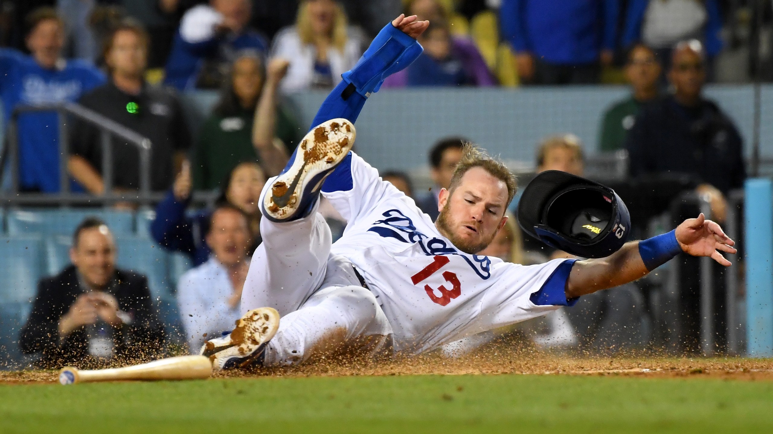 Max Muncy #13 of the Los Angeles Dodgers is safe at home as he gets past Francisco Cervelli #29 of the Pittsburgh Pirates to score a run on a sacrifice fly by Chris Taylor #3 of the Los Angeles Dodgers in the seventh inning of the game at Dodger Stadium on April 27, 2019 in Los Angeles, California. (Credit: Jayne Kamin-Oncea/Getty Images)