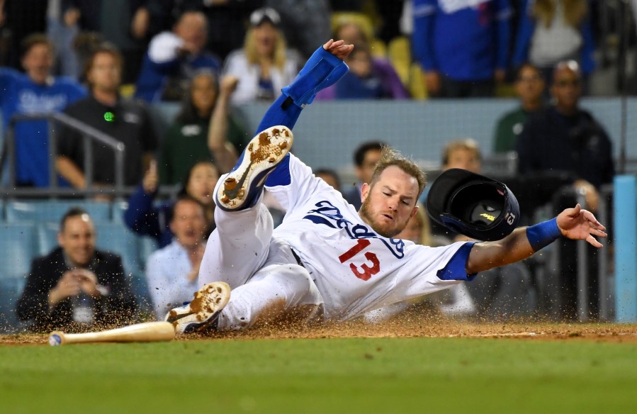 Max Muncy #13 of the Los Angeles Dodgers is safe at home as he gets past Francisco Cervelli #29 of the Pittsburgh Pirates to score a run on a sacrifice fly by Chris Taylor #3 of the Los Angeles Dodgers in the seventh inning of the game at Dodger Stadium on April 27, 2019 in Los Angeles, California. (Credit: Jayne Kamin-Oncea/Getty Images)