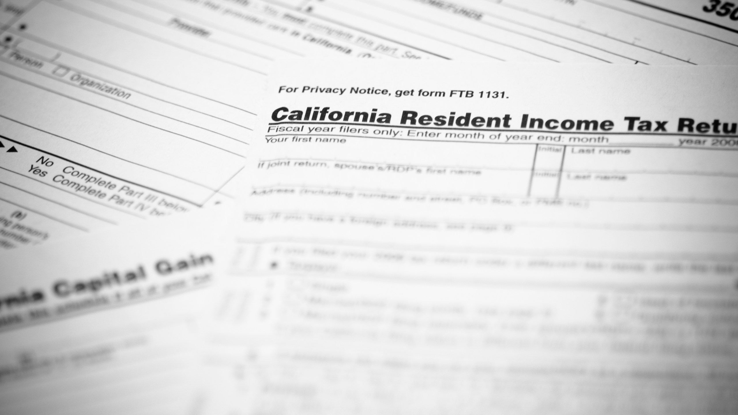 The California income tax form 540 with supplemental forms in the background in this file photo. (Credit: iStock / Getty Images Plus)