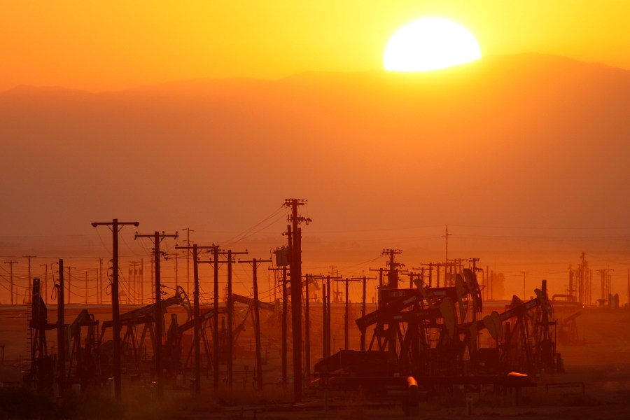 The sun rises over an oil field at the Monterey Shale formation on March 24, 2014, near Lost Hills, California. (Credit: David McNew/Getty Images)