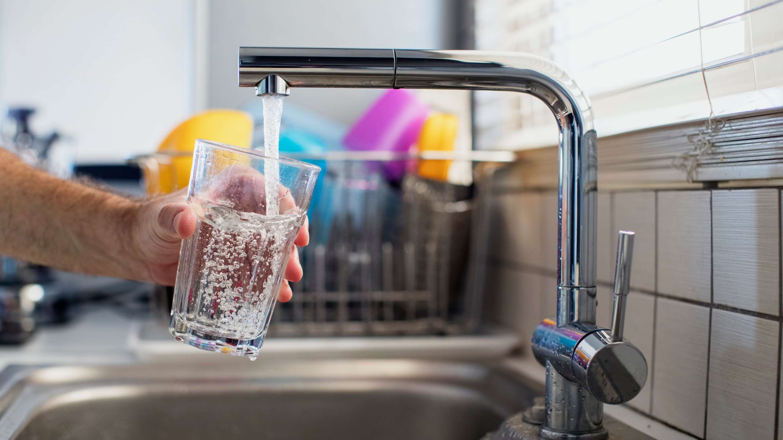 A man holding a glass of water is seen in this file photo. (Credit: Thanasis Zovoilis via Getty Images)